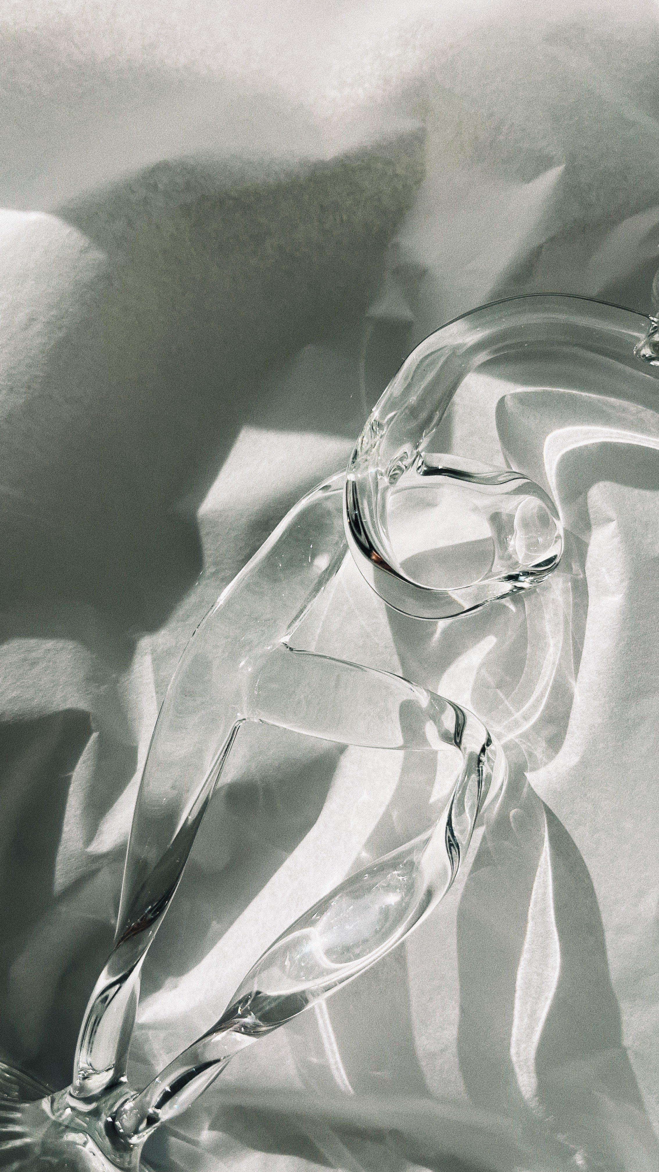 Clear glass ribbon candleholder with flowing curved form detail