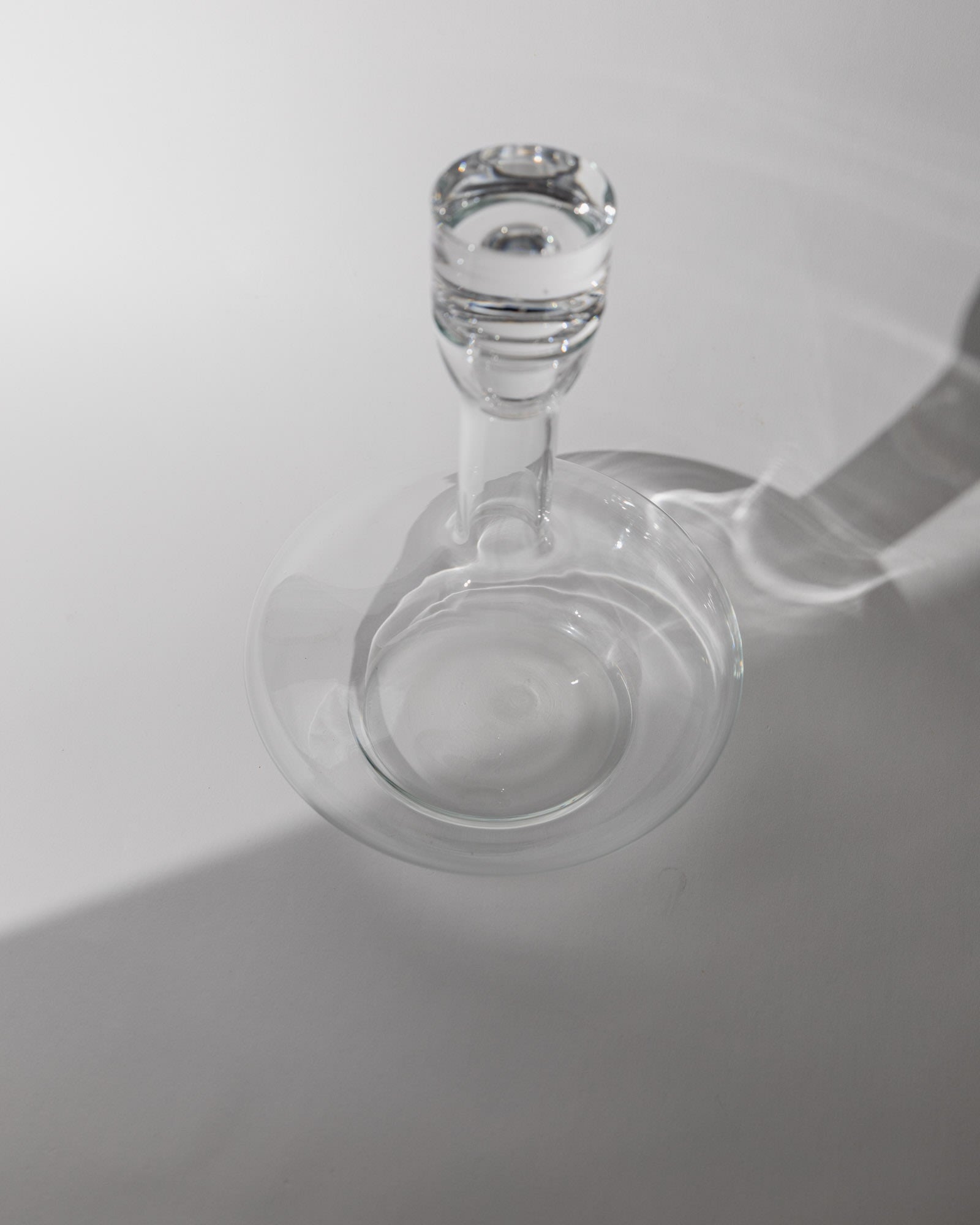 Vintage 1980s Glass Decanter, Italian Glass Ware with Glass Stopper — top view on white surface