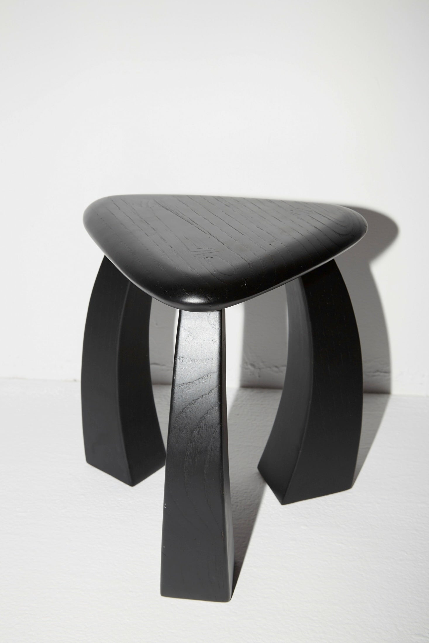 Arc de Stool '37 — angled view of black wooden stool
