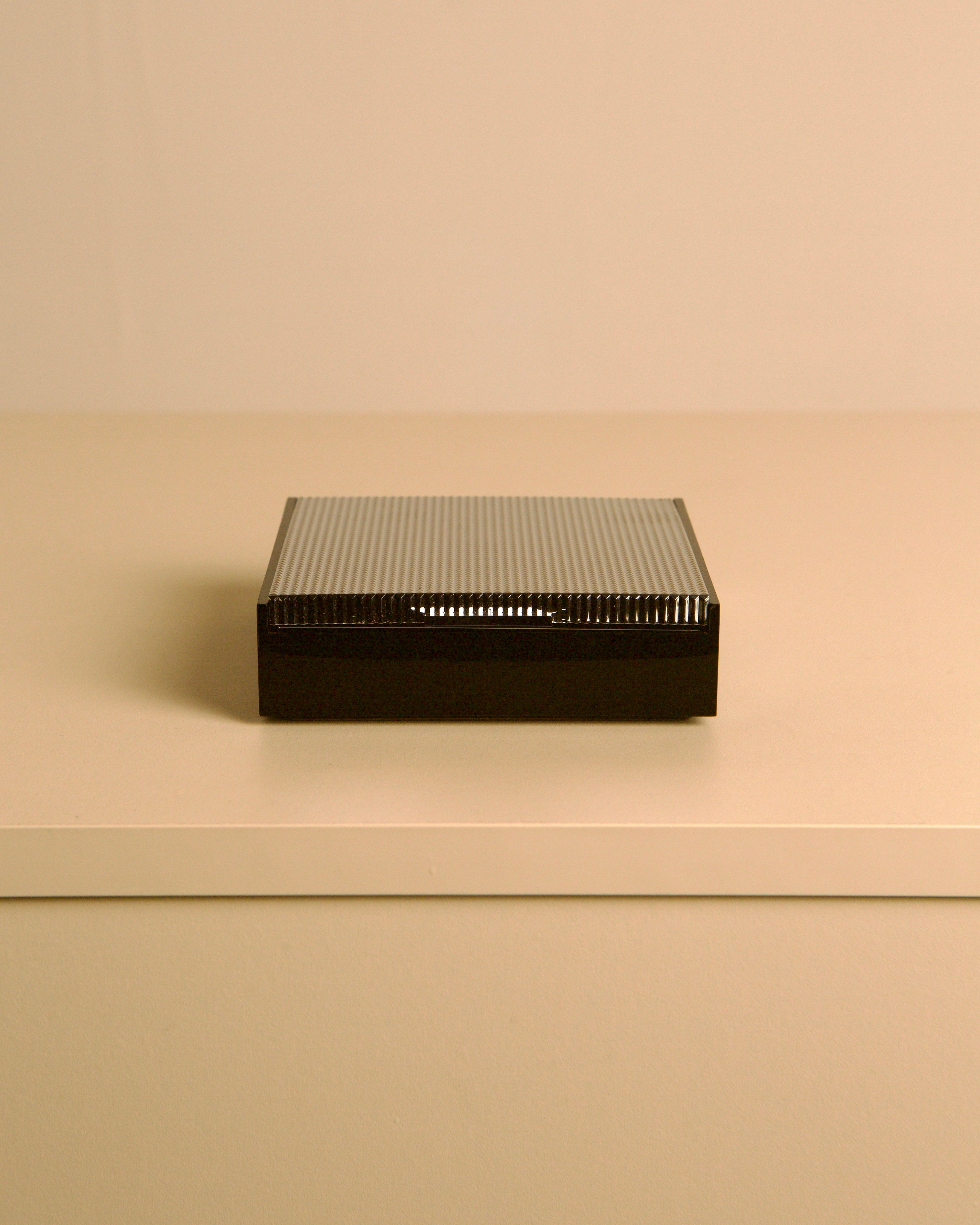 Italian box made of metal and plastic, 80s — top view on neutral surface