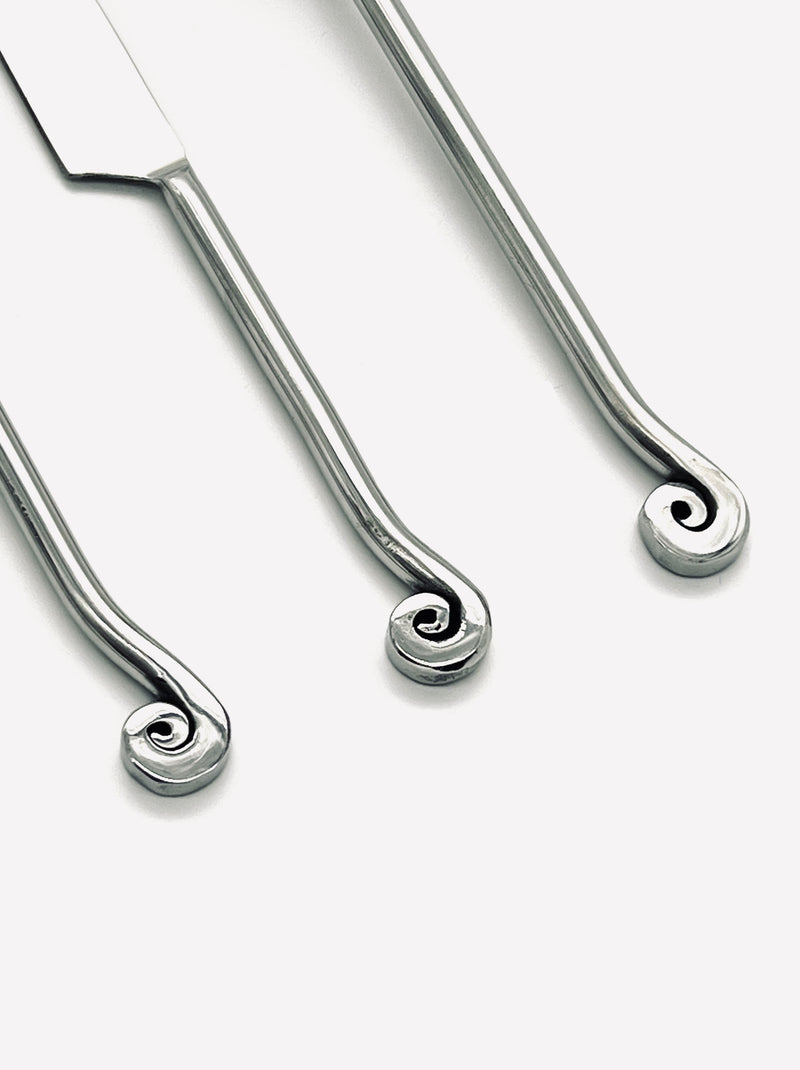 Close-up detail of spiral-ended handles on stainless steel cutlery