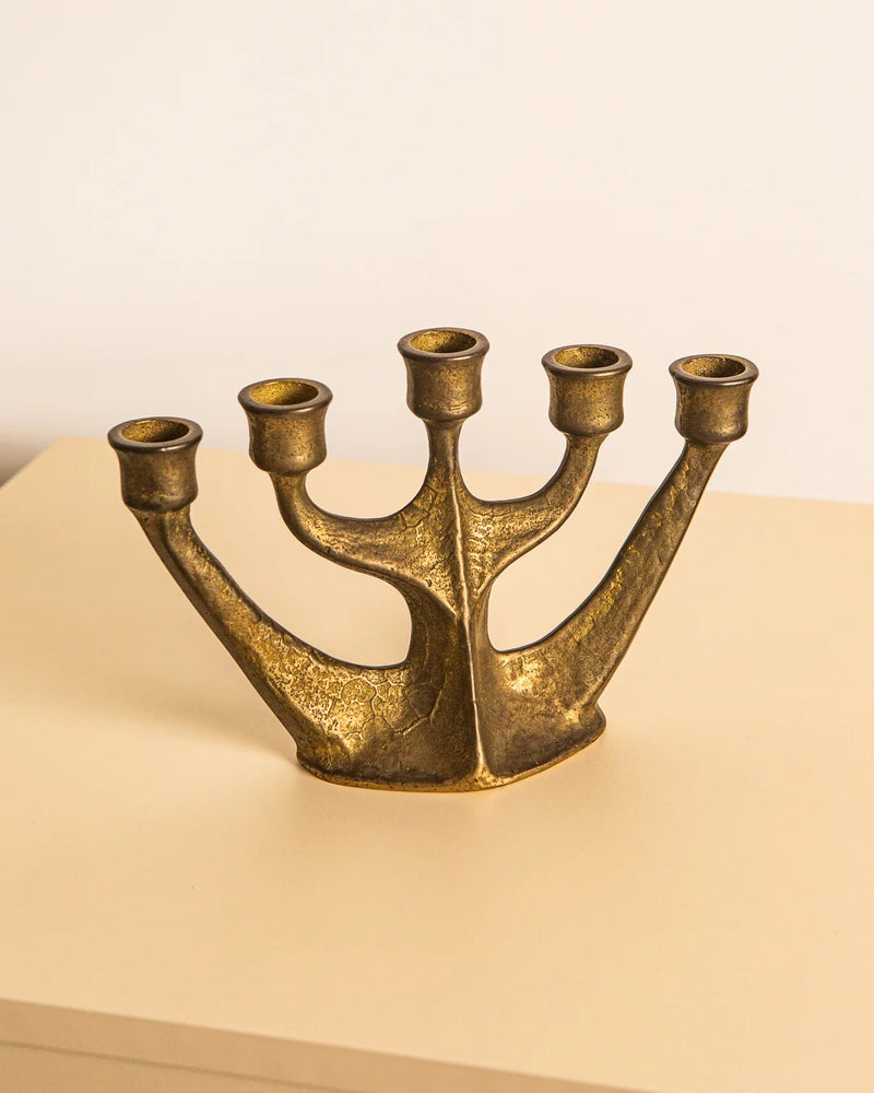 Vintage brass five-arm candleholder showing sculptural branched design