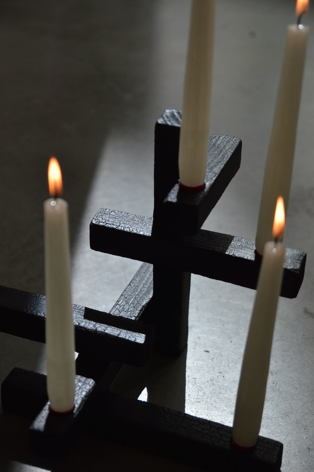 TETRIS 5 — close-up of black textured candle holders with white candles