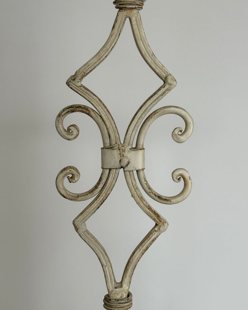 Ornate scrollwork detail of antique white metal candleholder