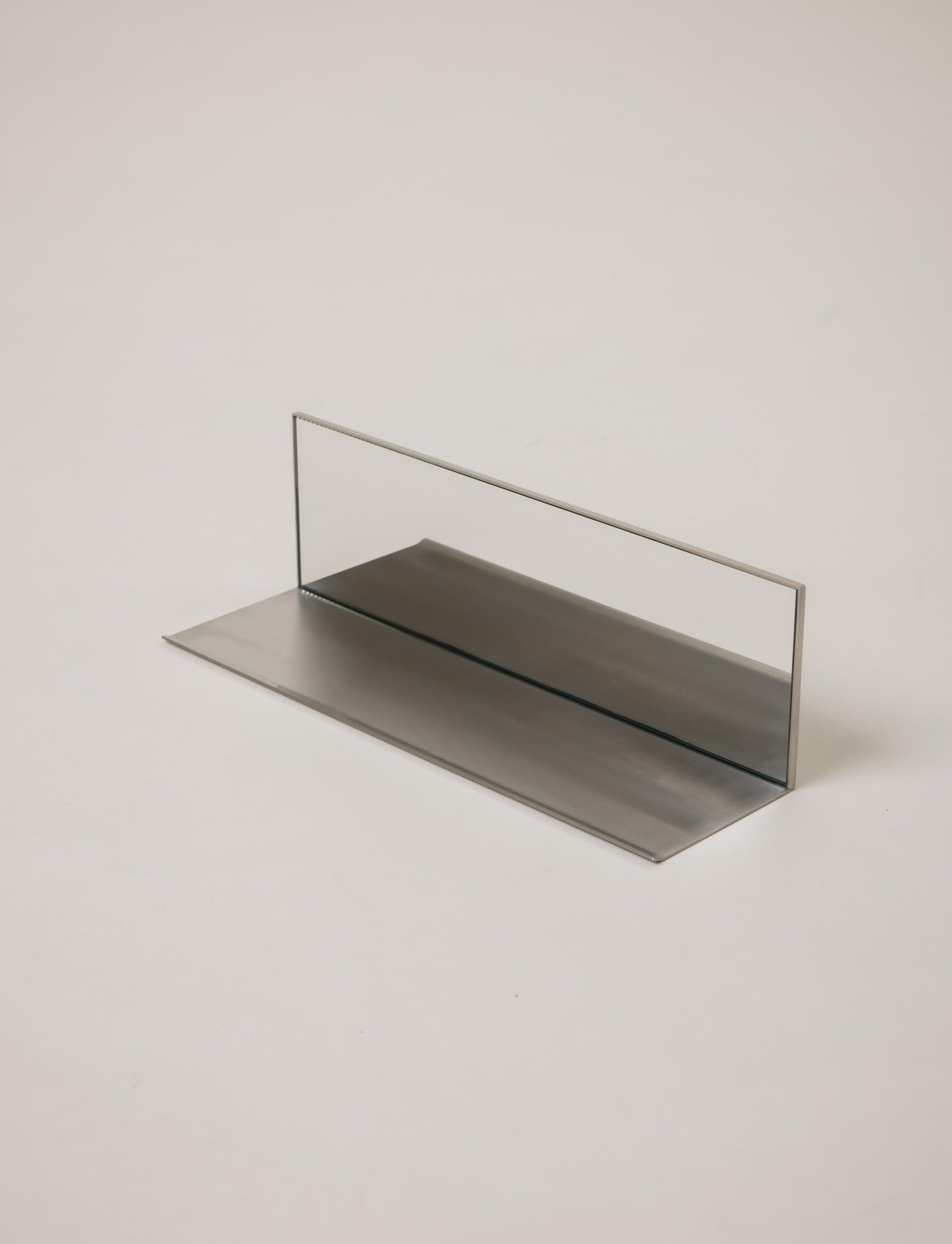 Mirror Steel Shelf — angled view showing reflective surface and metal base