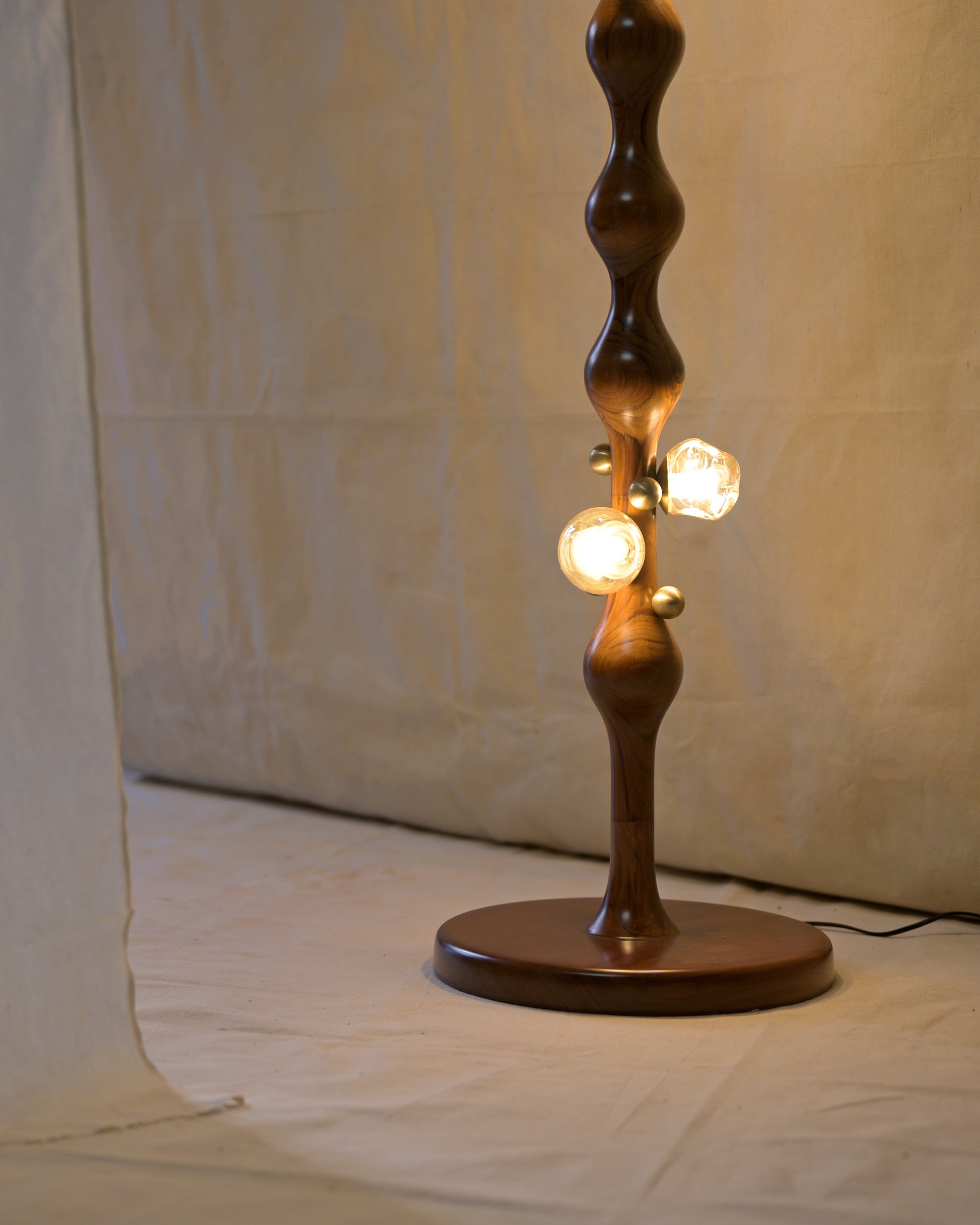 Stem Floor Lamp — close-up of wooden base with light bulbs