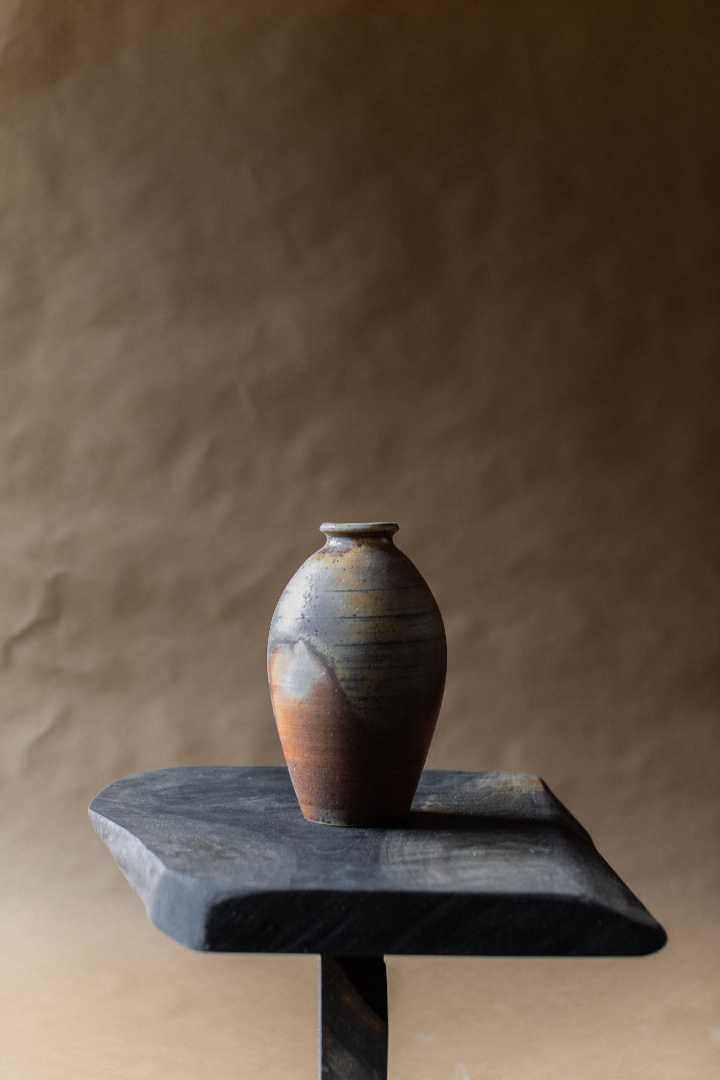Vintage Ceramic Vase — angled view on dark wooden pedestal
