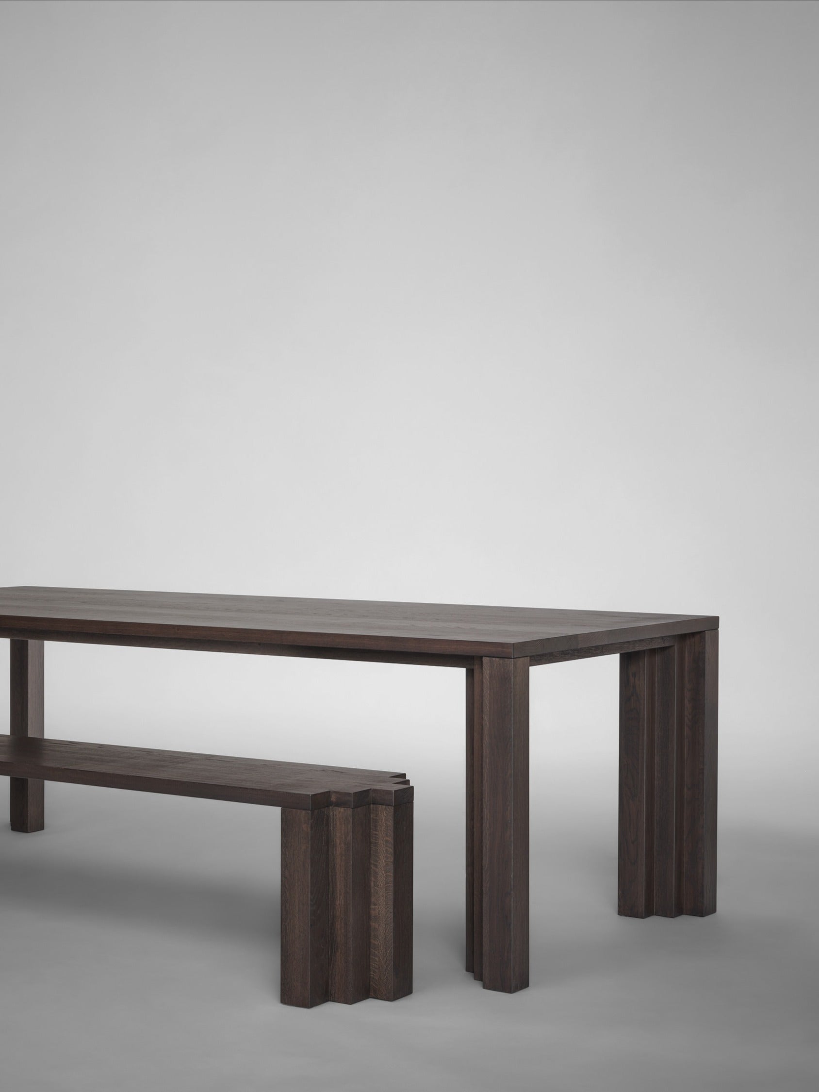 Cadence Bench — back view of dark wood in minimalist setting