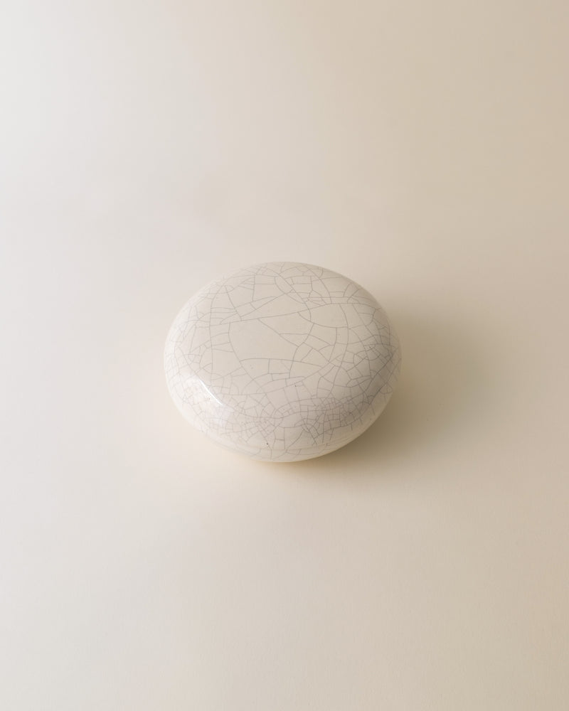Crackled white ceramic Longwy jar showing detailed surface texture