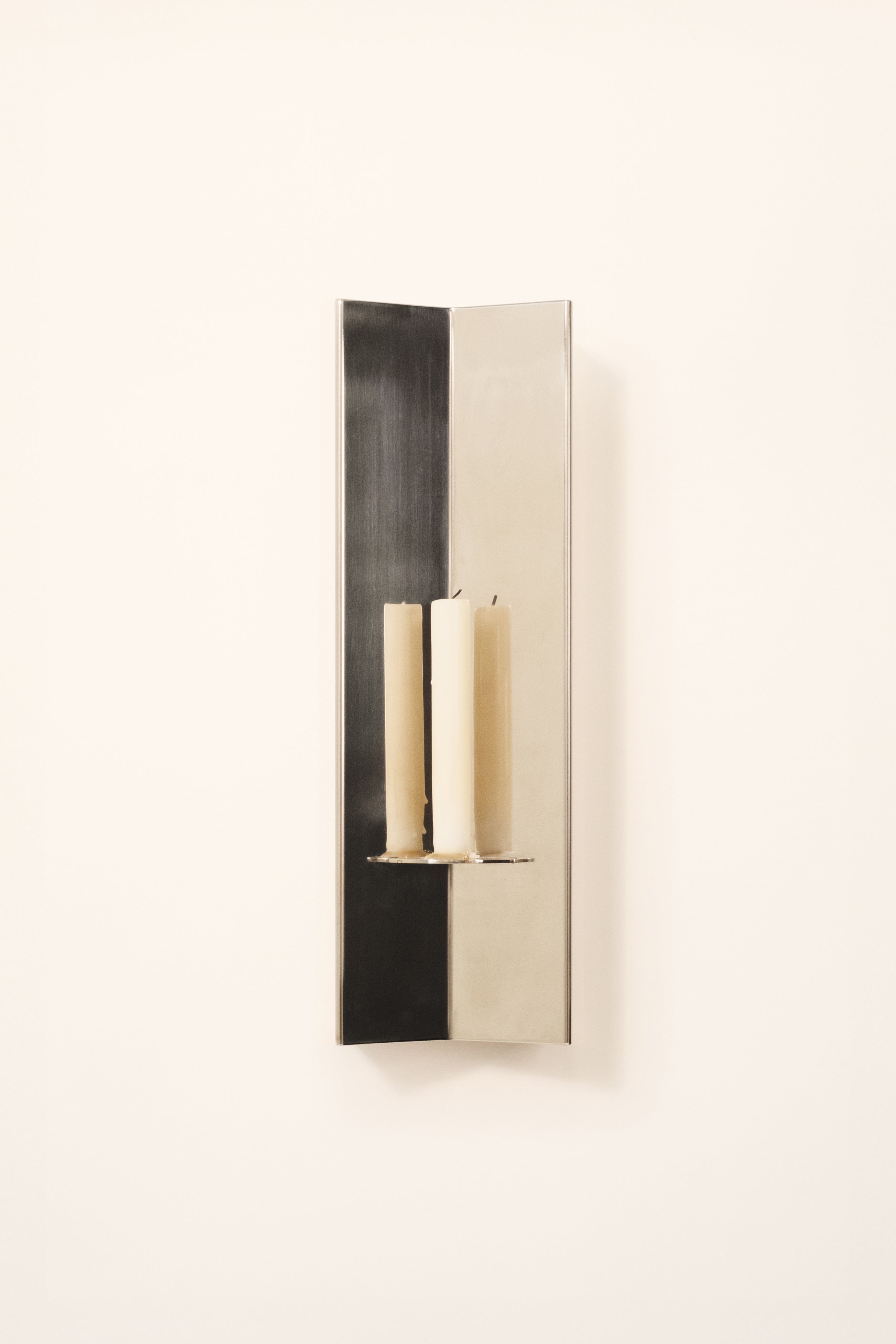 Arrow Candle Holder — side view showing polished metal finish and candles