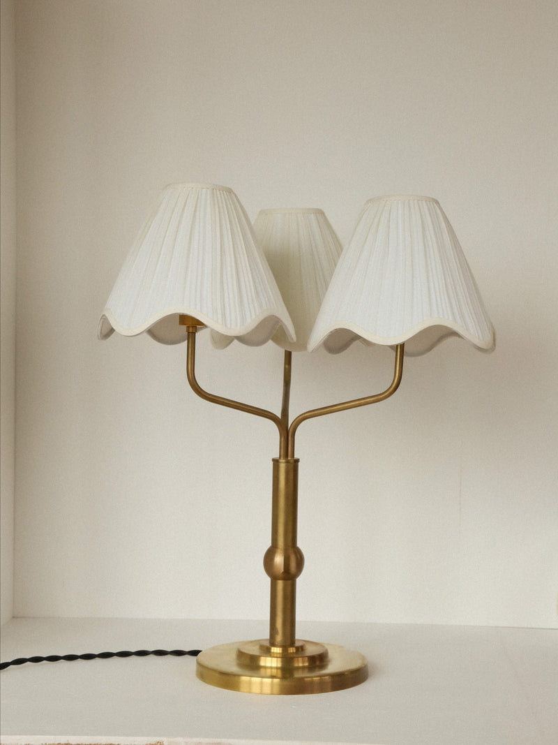Rosie brass table lamp with three white pleated fabric shades