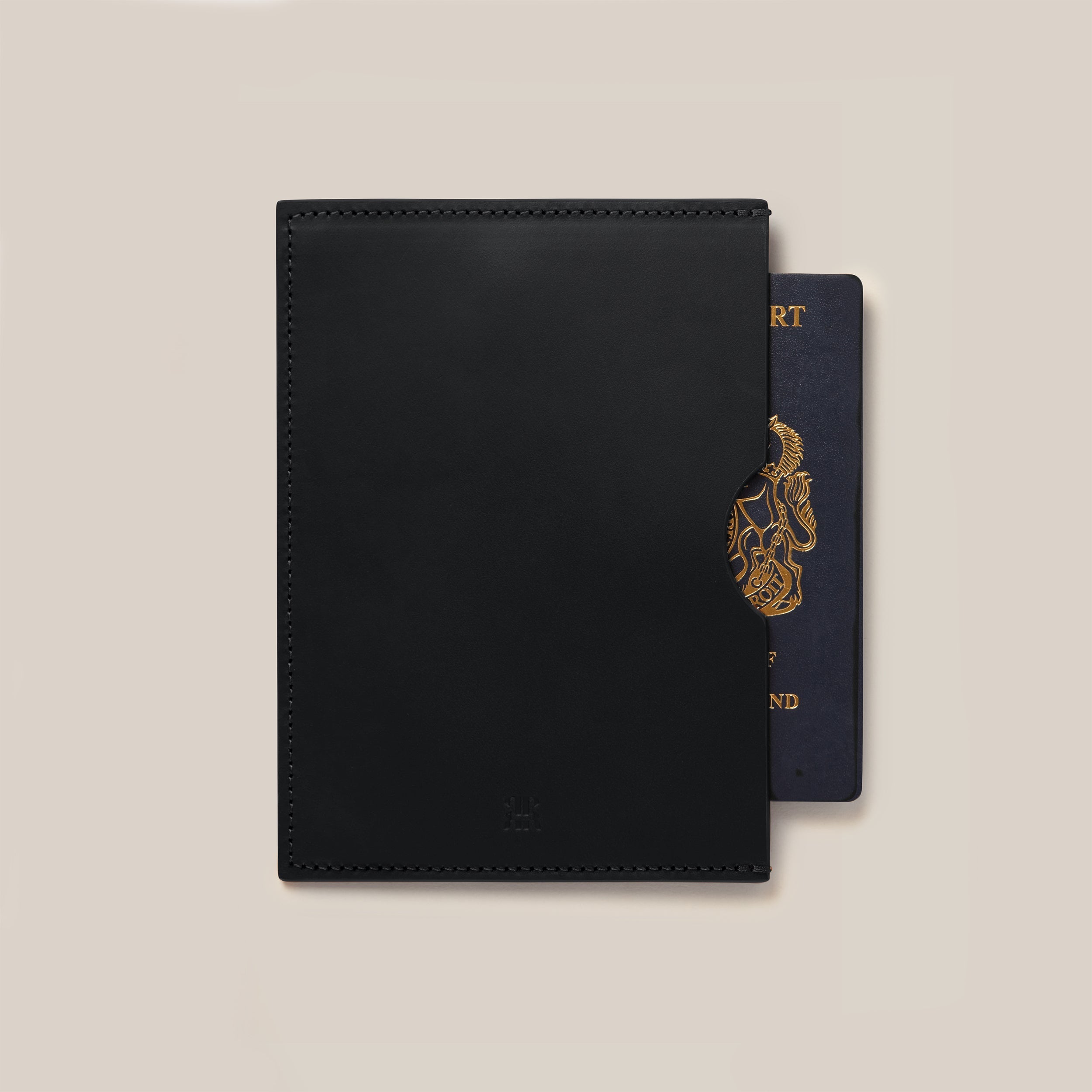 Leather Passport Holder — close-up of black leather texture with passport visible