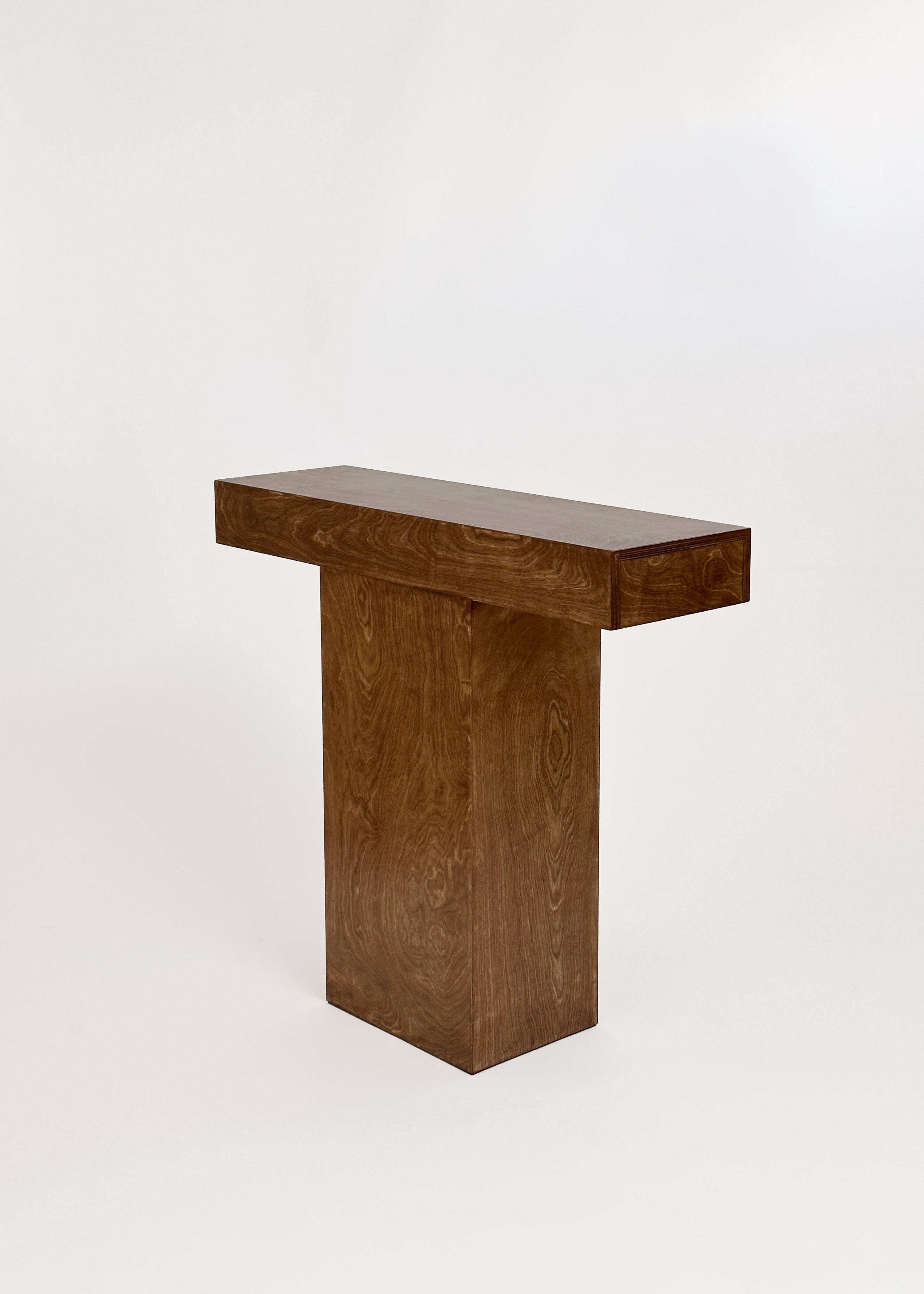 The Truss Console 02 by GOONS is a minimalist console table with a rectangular wooden top and solid central base, designed by Paris studio Goons, shown against a plain white background.