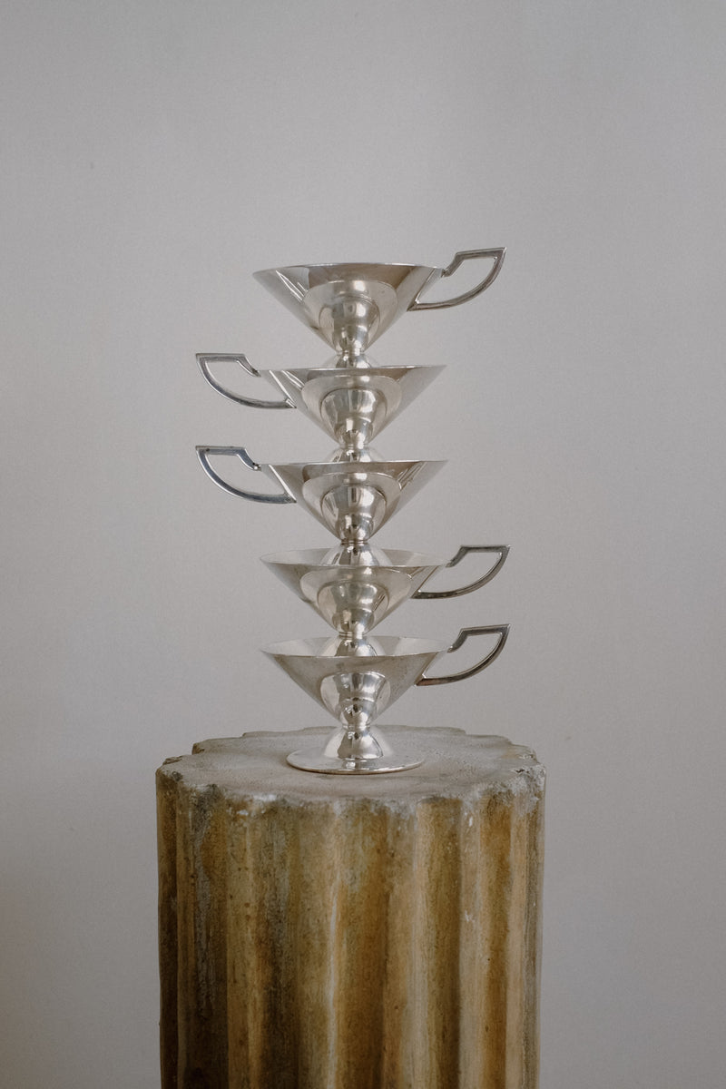 Set of Serving Cups in Silver — stacked view on textured pedestal