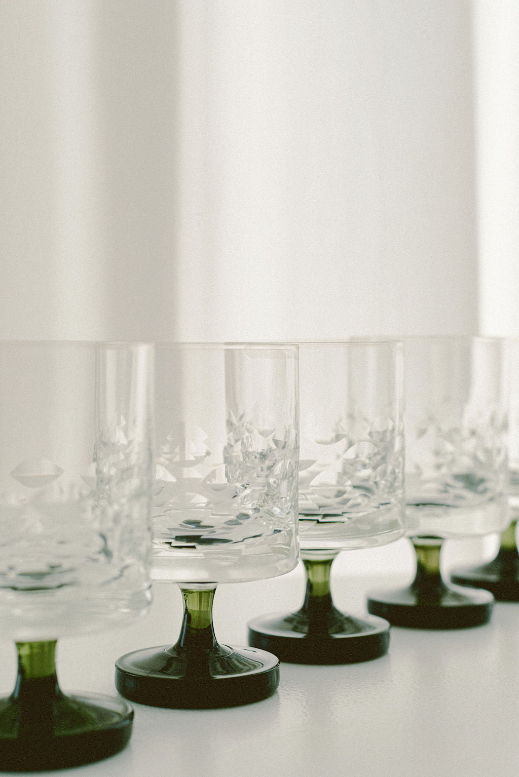 Vintage Ingrid Wine Glasses — side angle showing clear glass and green bases