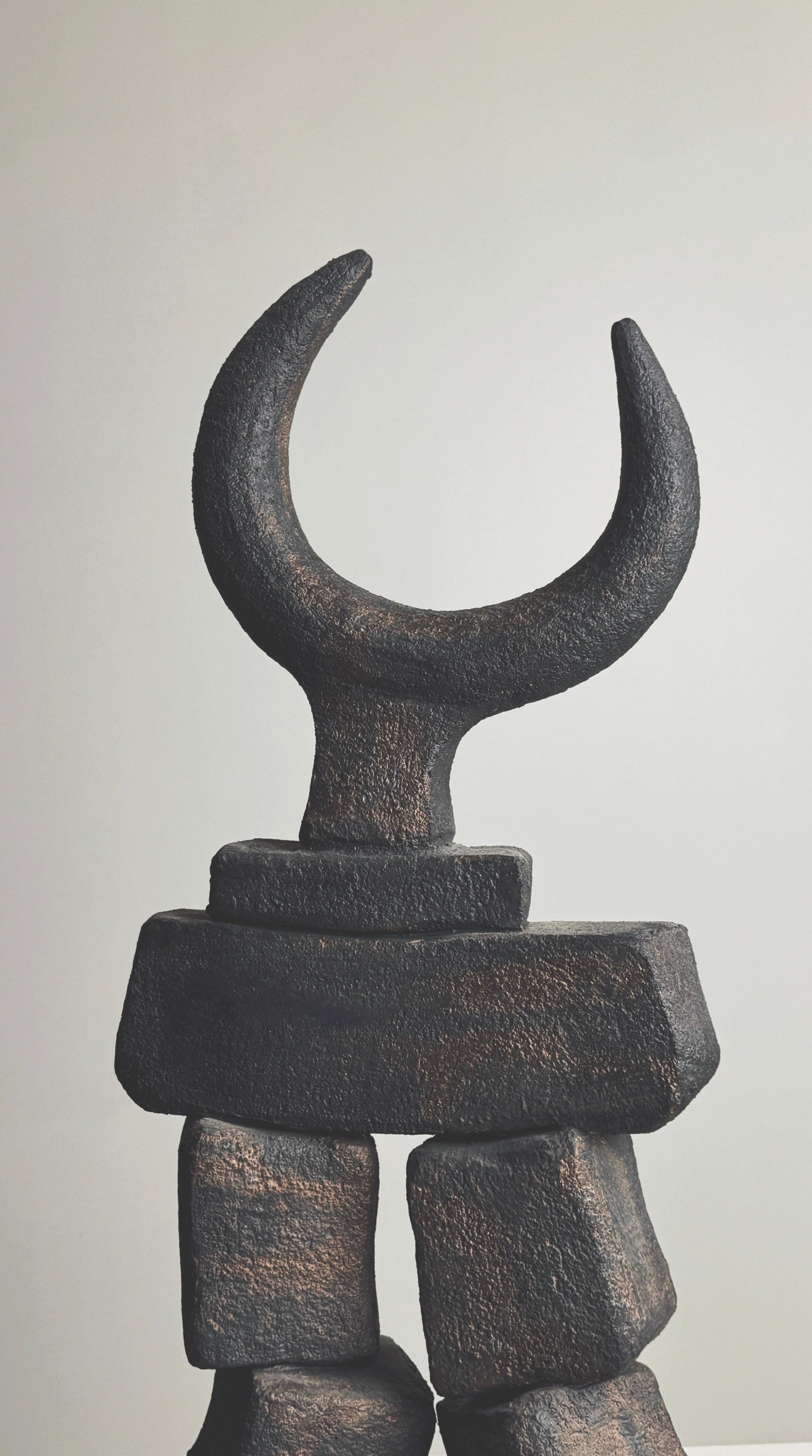 Dark bronze sculptural totem with crescent moon form by Pouchain