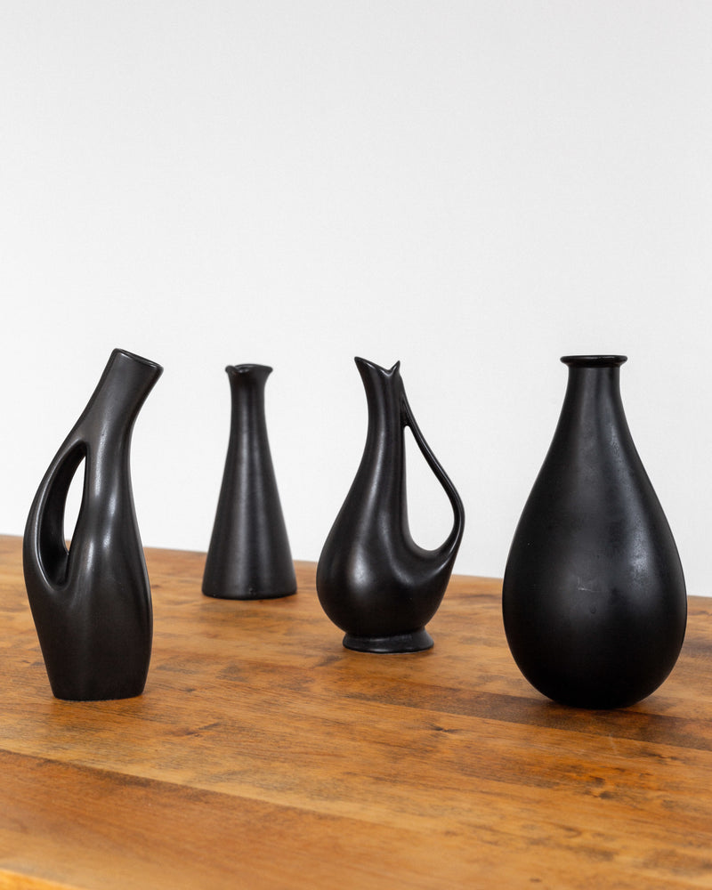 Collection of Black Sculptural Vases, Swedish Mid-Century Modern — close-up of four vases on wooden table