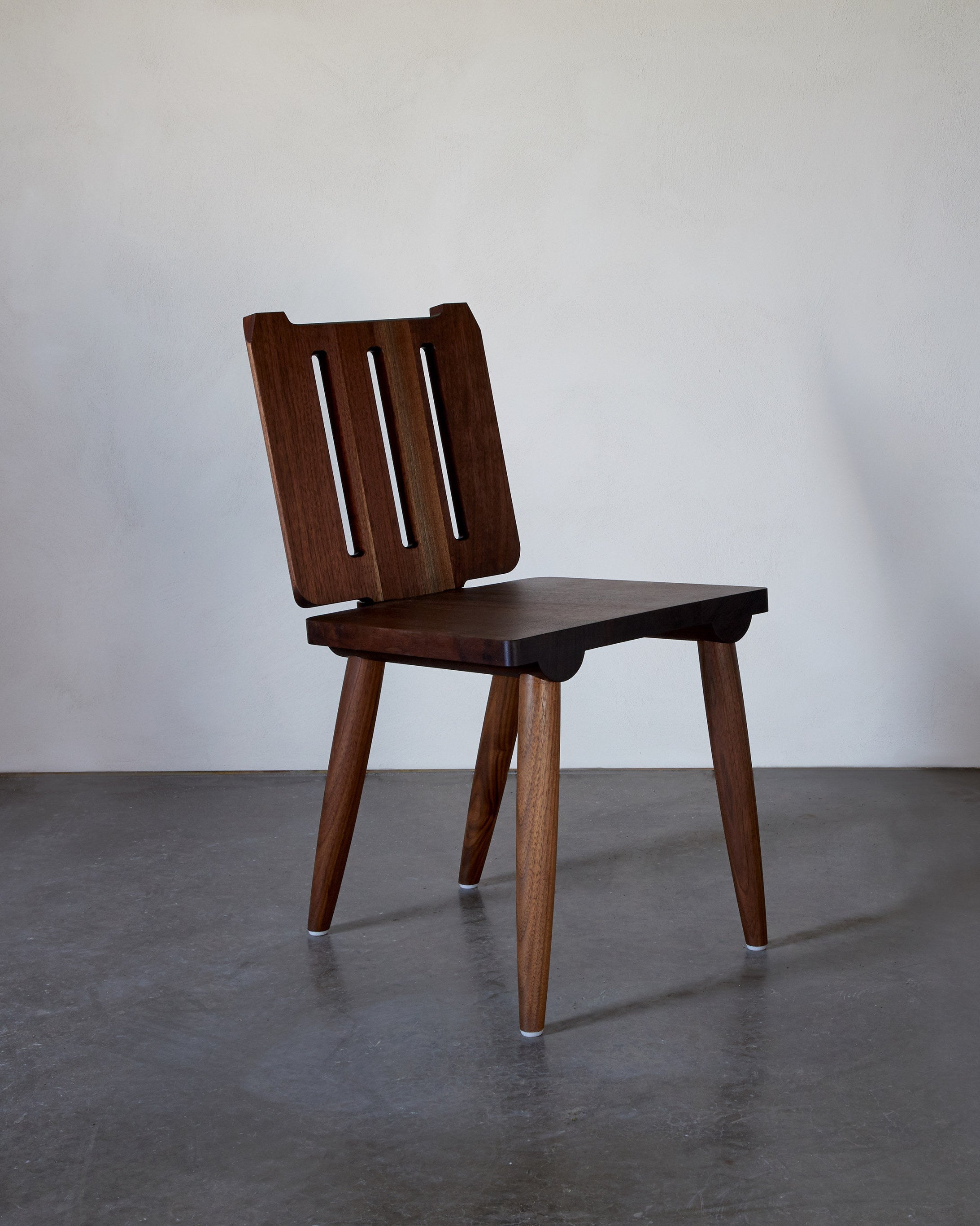 Alpine Chair — side view of handcrafted walnut wood design