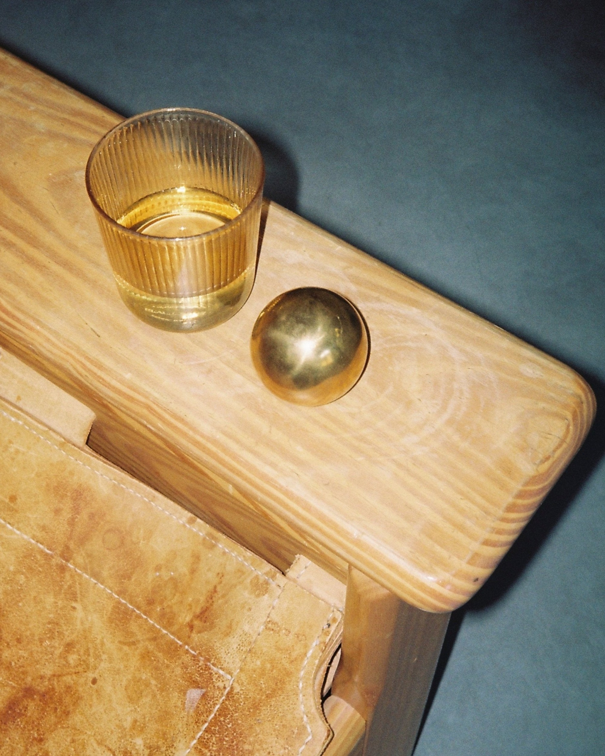 CERCLE Cabinet Knob Large — brass knob on wooden surface with glass tumbler