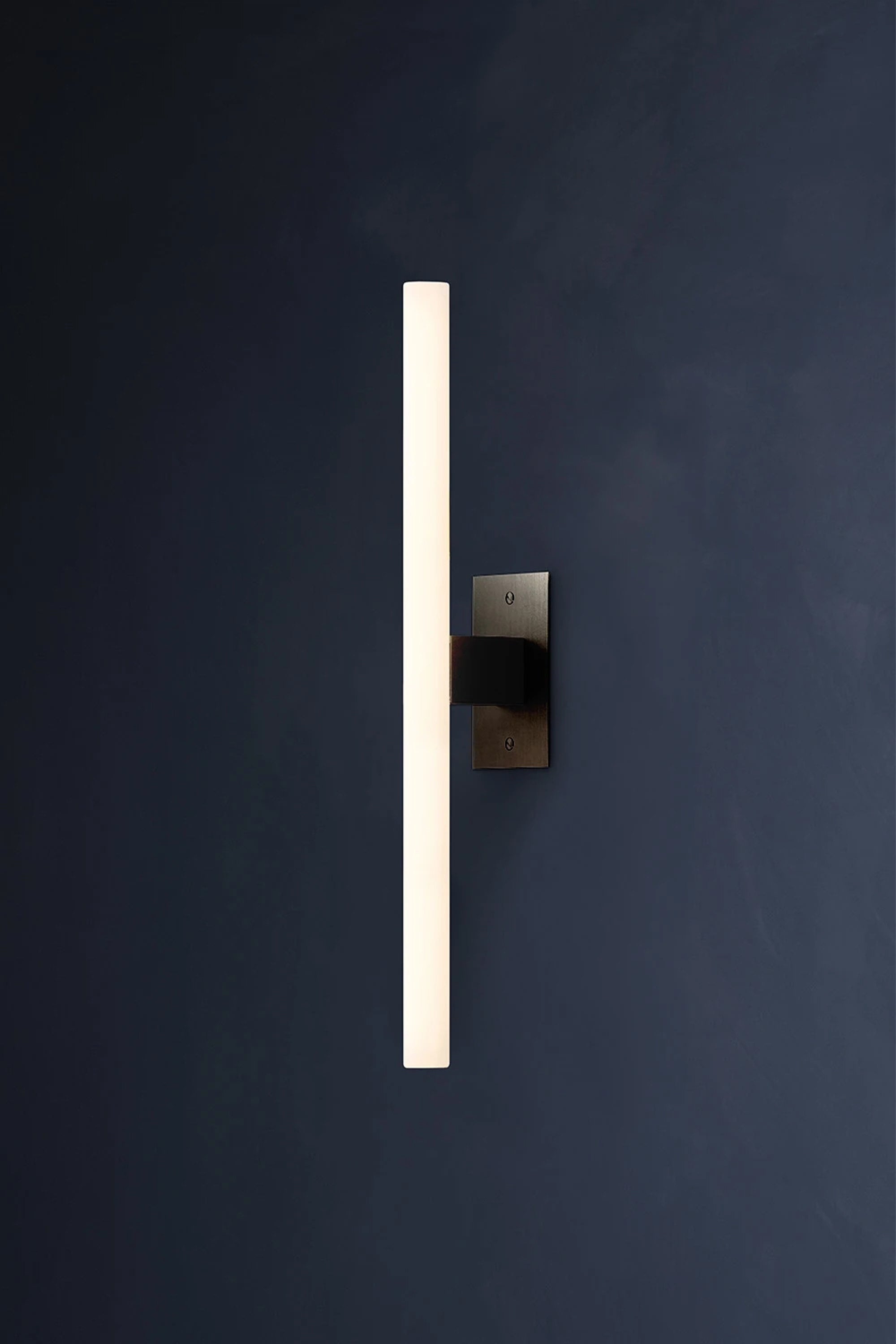 NEA WALL PLATE 50 — top view of modern wall light in dark setting