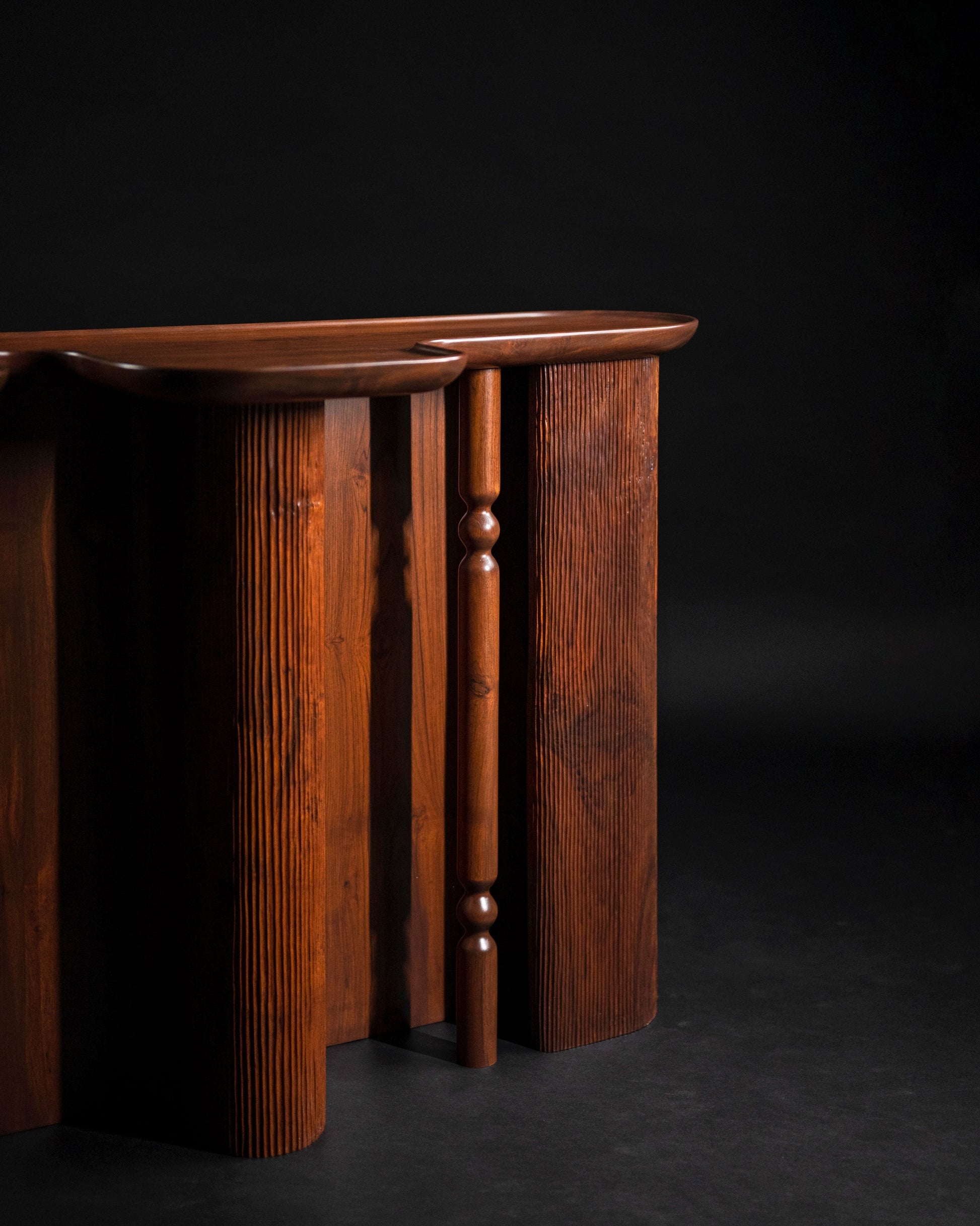 Ridge Console Table — close-up of dark wood texture and curved edges