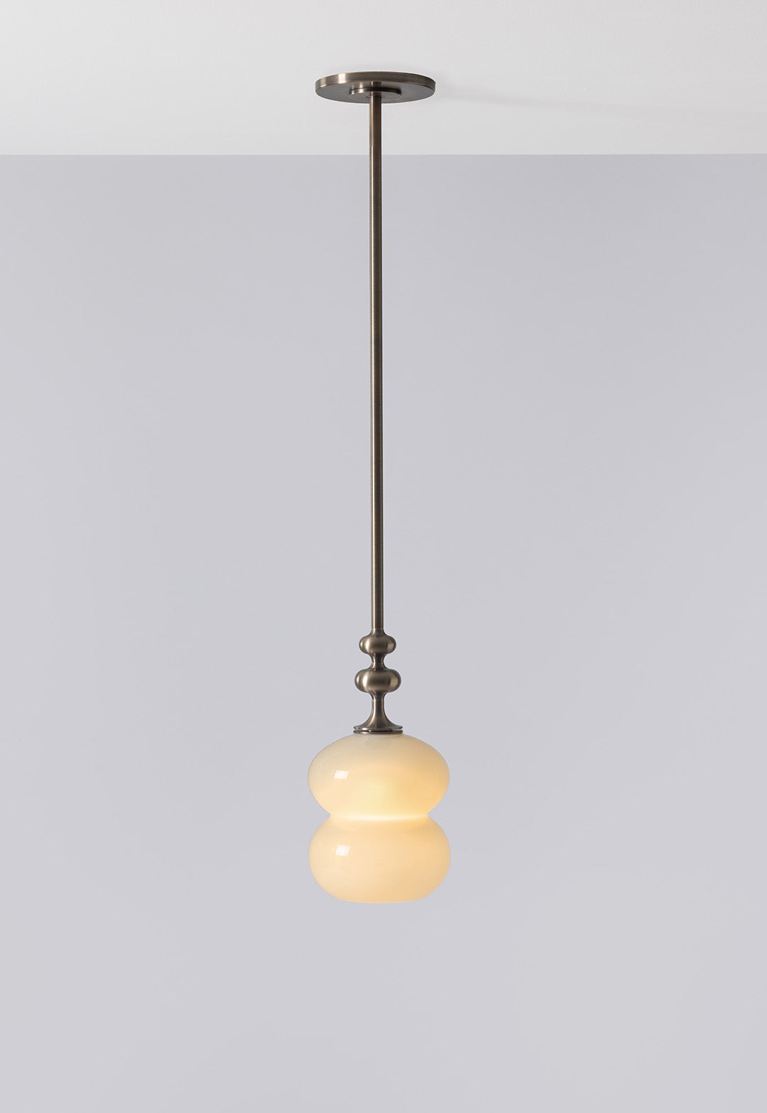 SkLO + AvroKO Oestre Pendant - Light Beige glass, Antique Brass finish — side angle