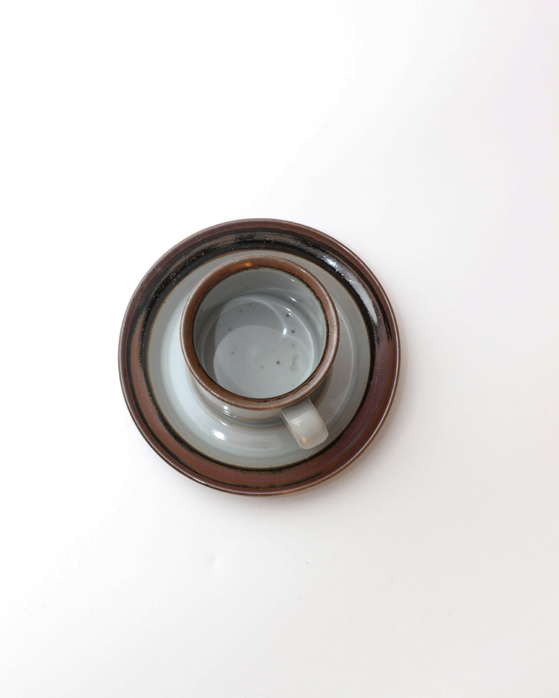Set of Four Ceramic Cups with Saucers — top view of gray cup on saucer