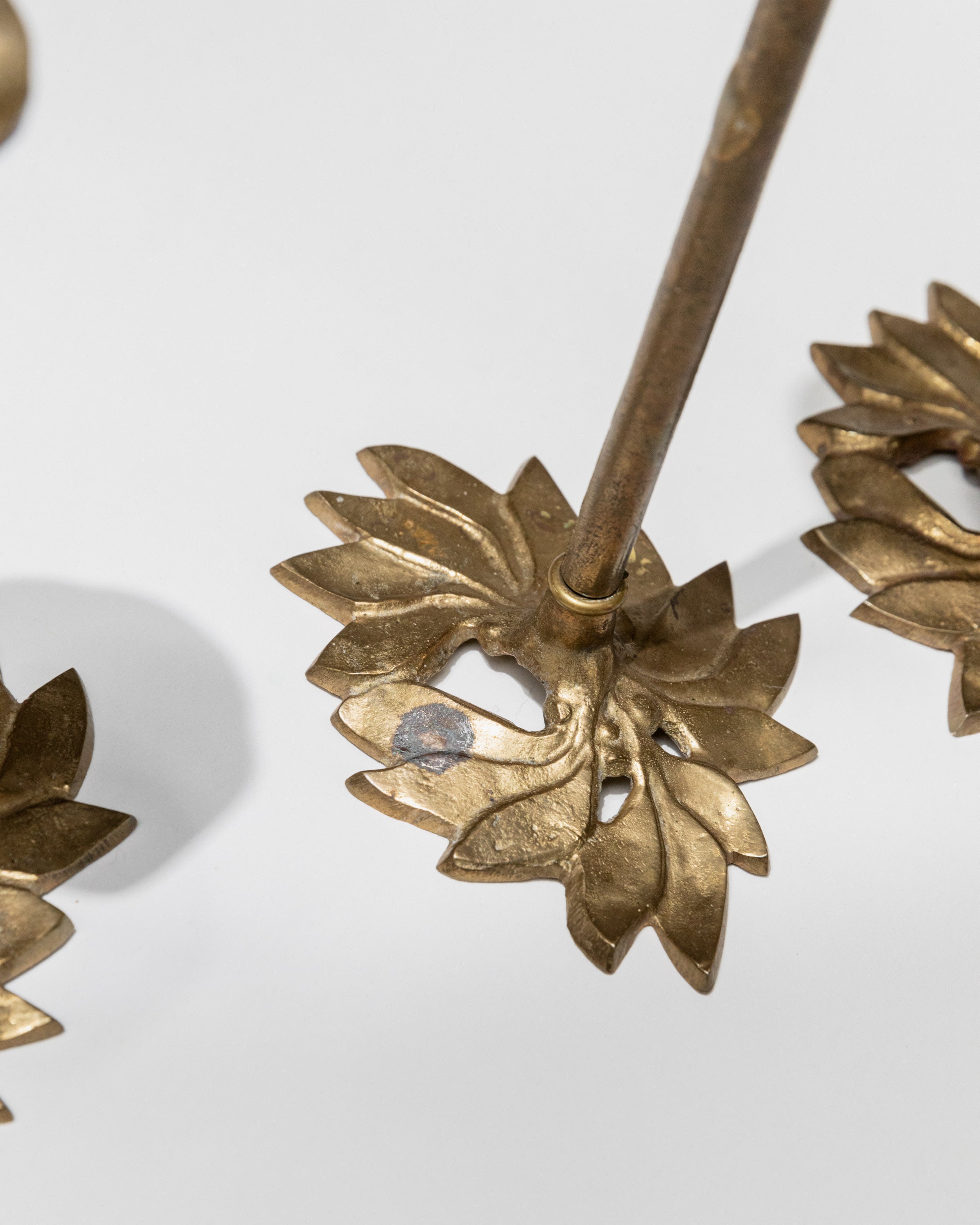 Brass floral candle holder detail showing sculptural petals