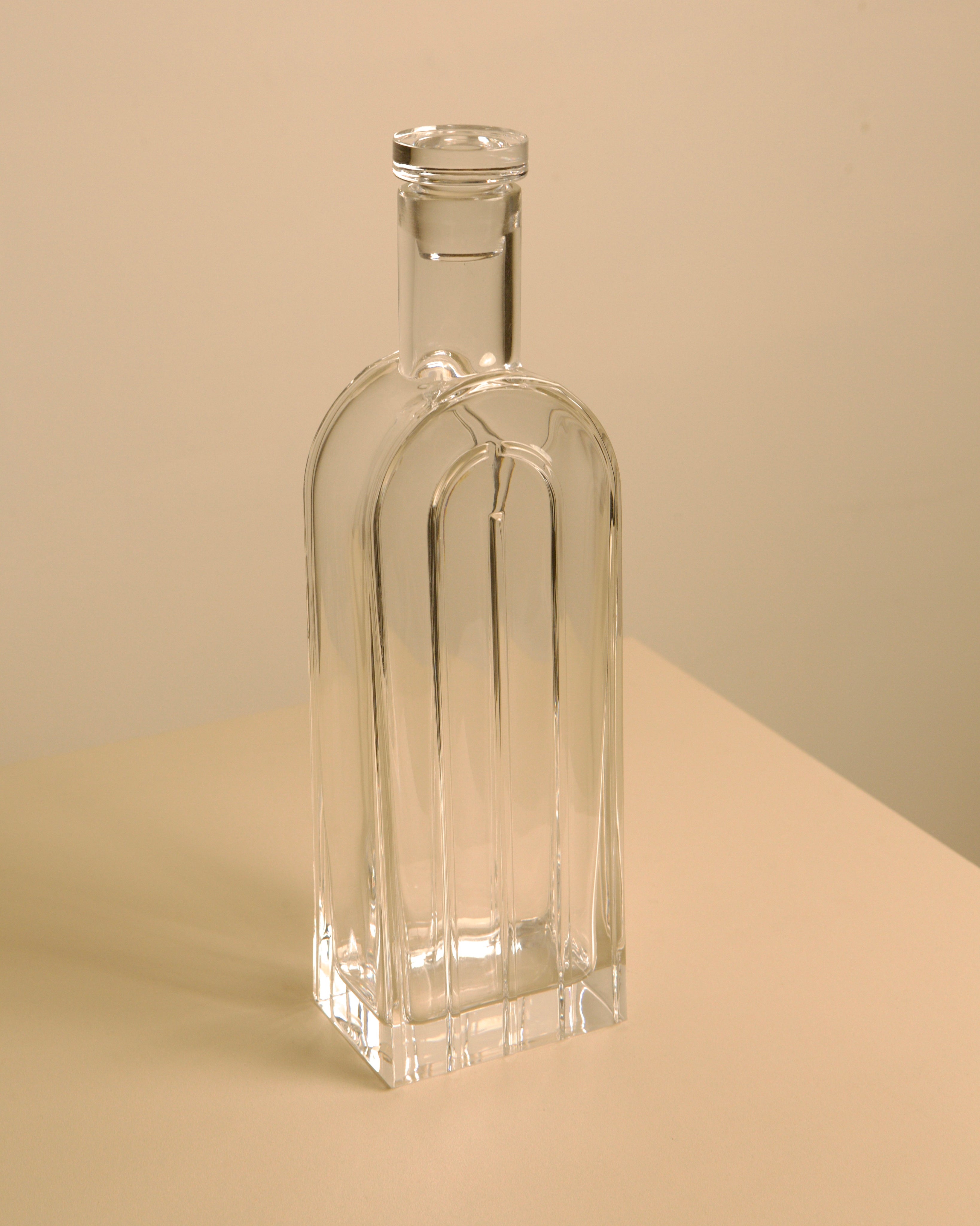 Clear crystal bottle vase showing elegant elongated form and cork