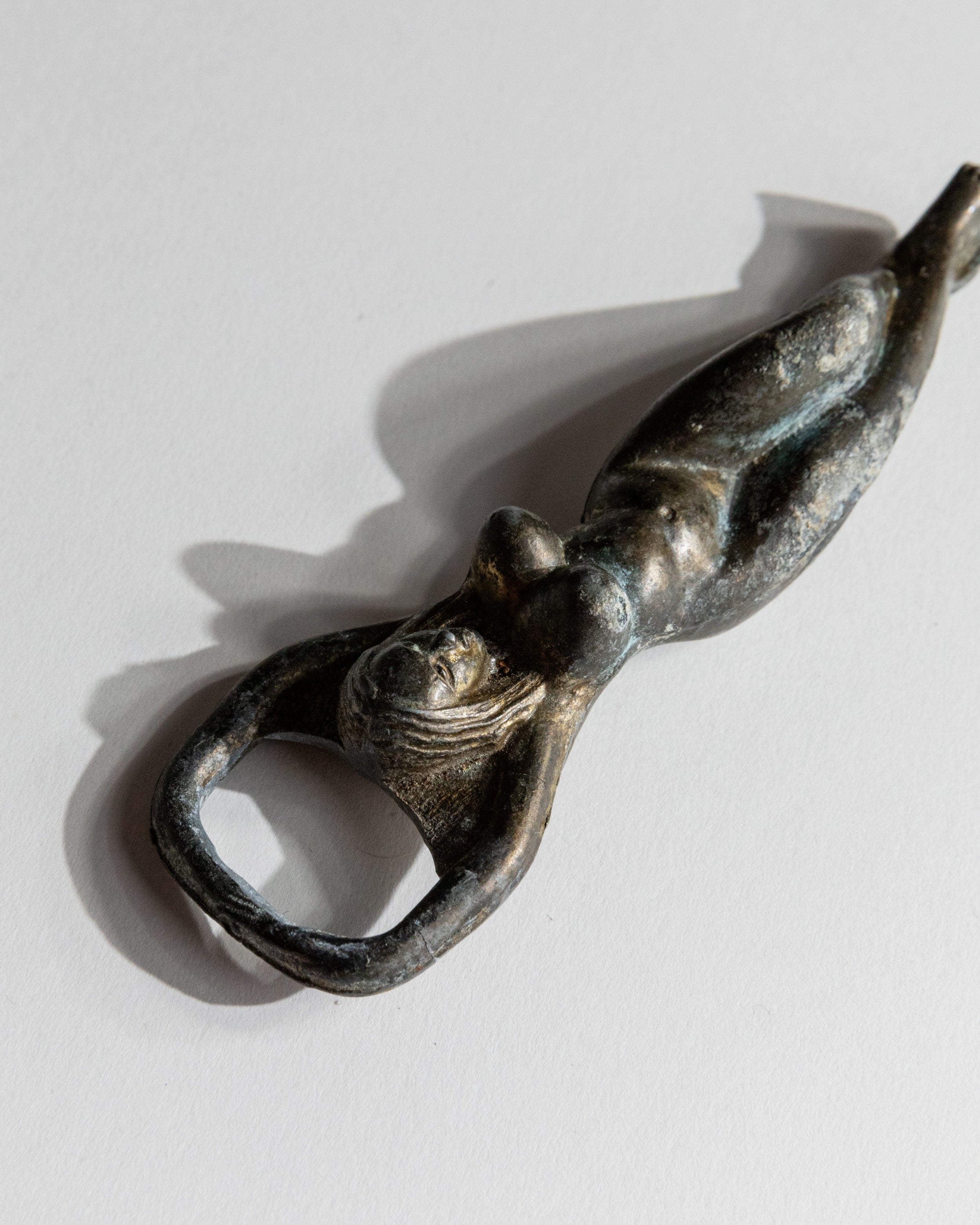 Vintage 1940s Bottle Opener Brass, Nude Woman Shape — angled view highlighting the figure's detail