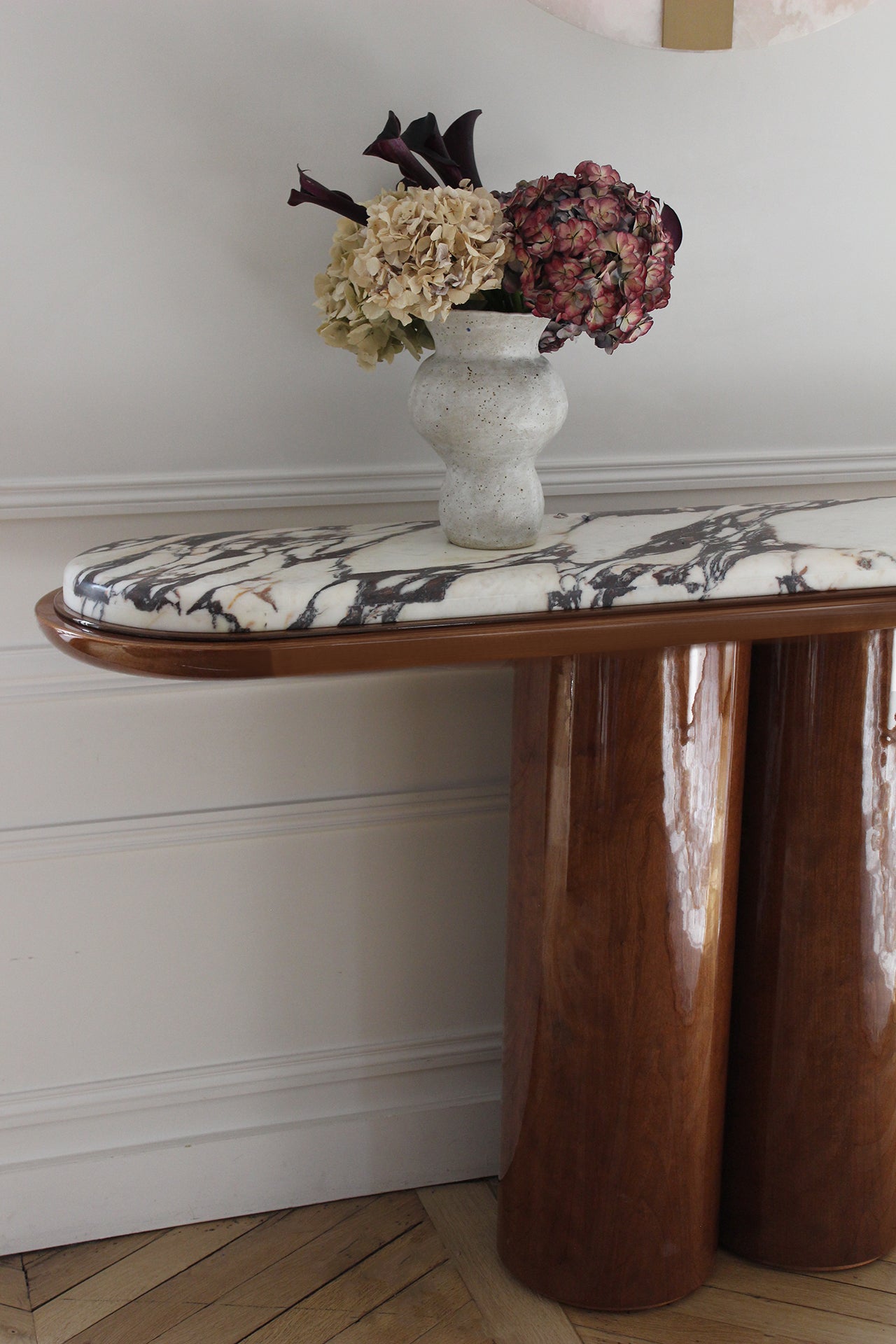 Ida Wood And Calacatta Viola Marble Console — top view with floral arrangement