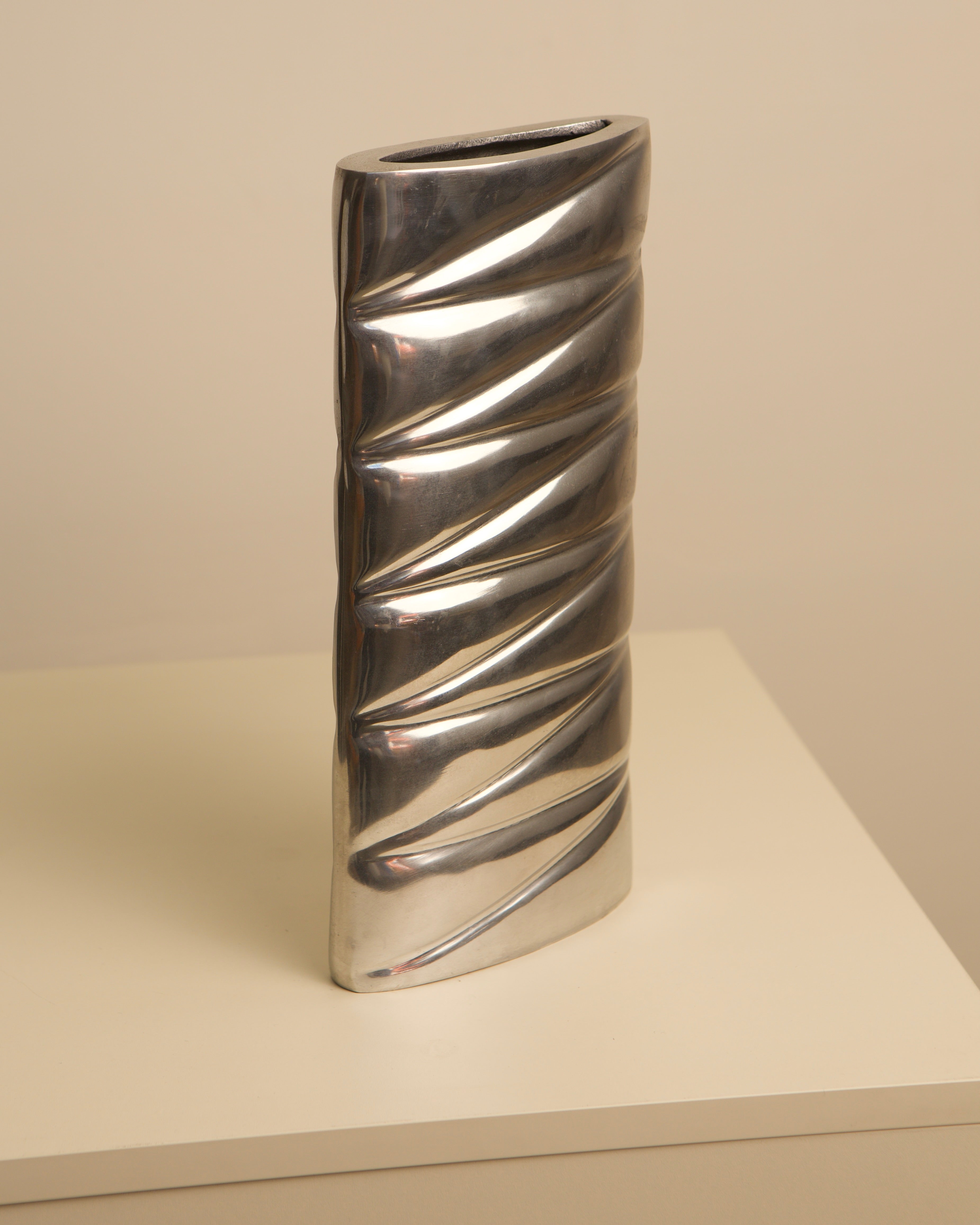 Spiral ridged cast aluminum vase showing sculptural twisted form