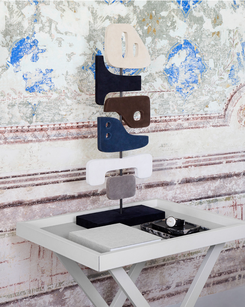 Modern sculptural totem with stacked geometric forms in mixed materials