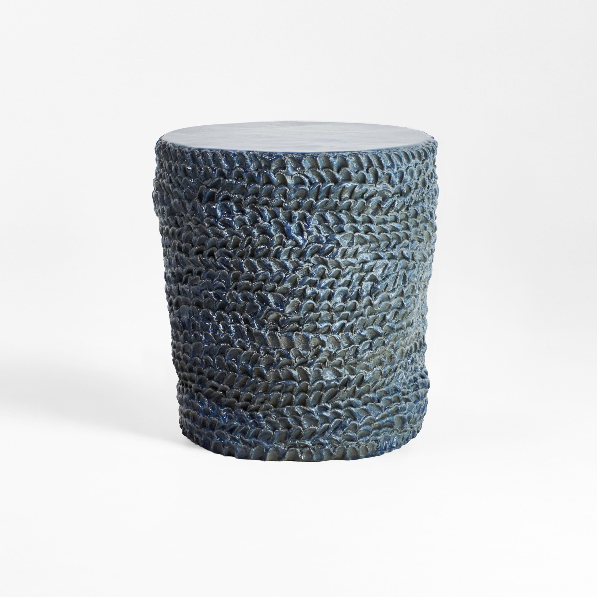 Casa Ceramic Side Table — textured blue ceramic surface in minimalist setting