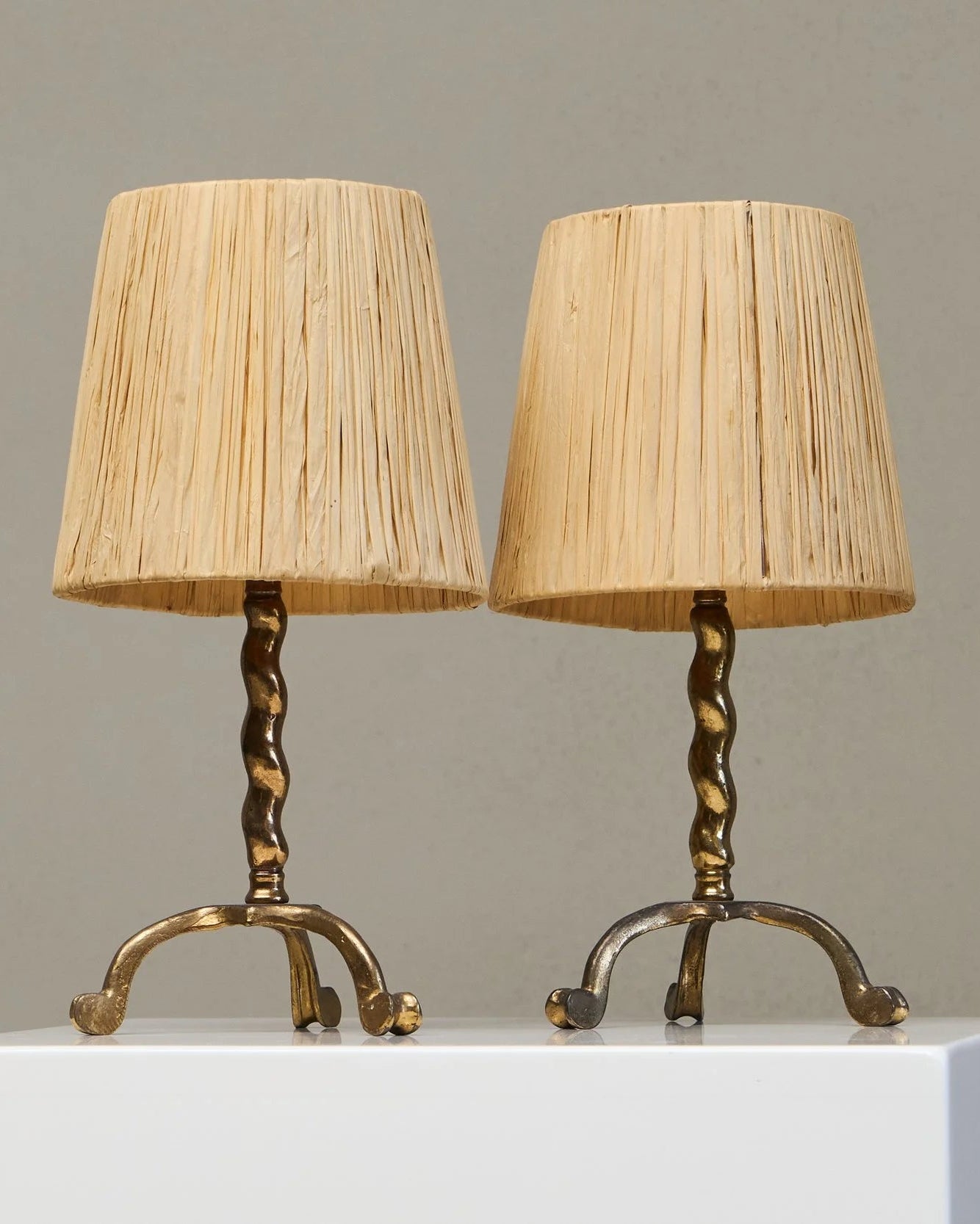 Wonderful Pair of Tripod Table Lamps in Patinated Sand Cast Brass with Raffia Shades by ORNAMENTUM | The Oblist