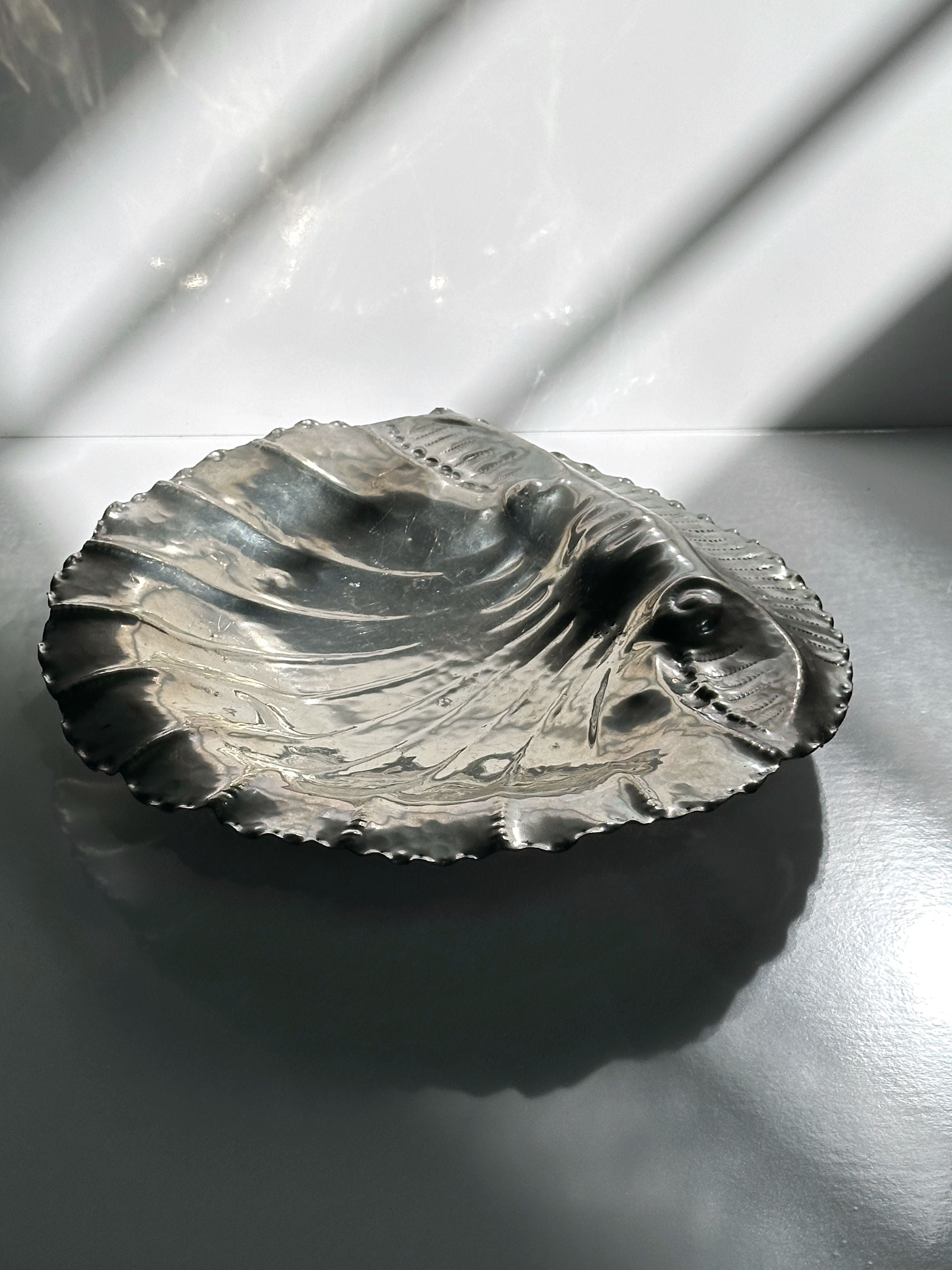 Handmade tin shell bowl artistic detail with textured surface