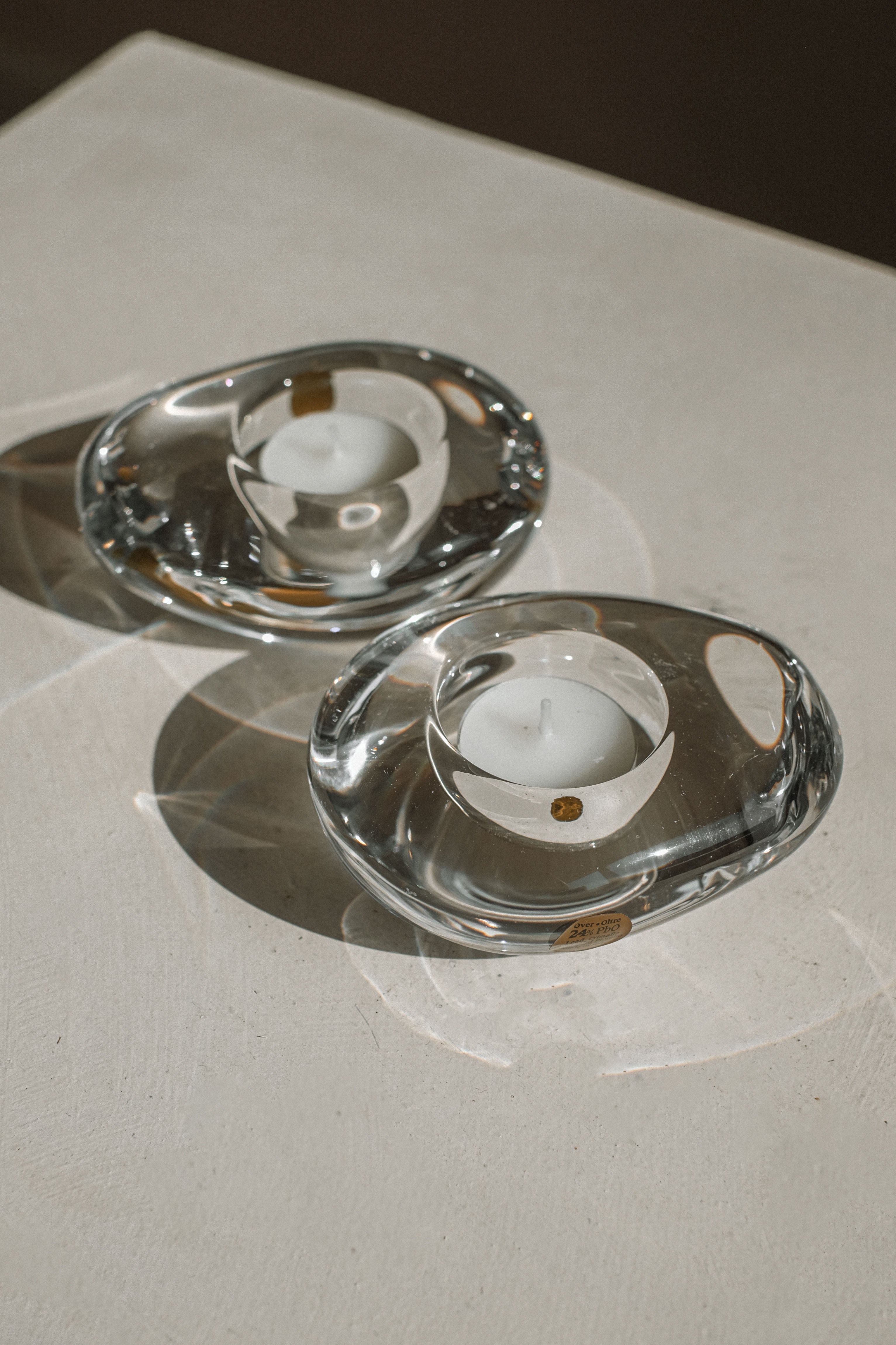 Clear crystal tealight holders with white candles, detail view