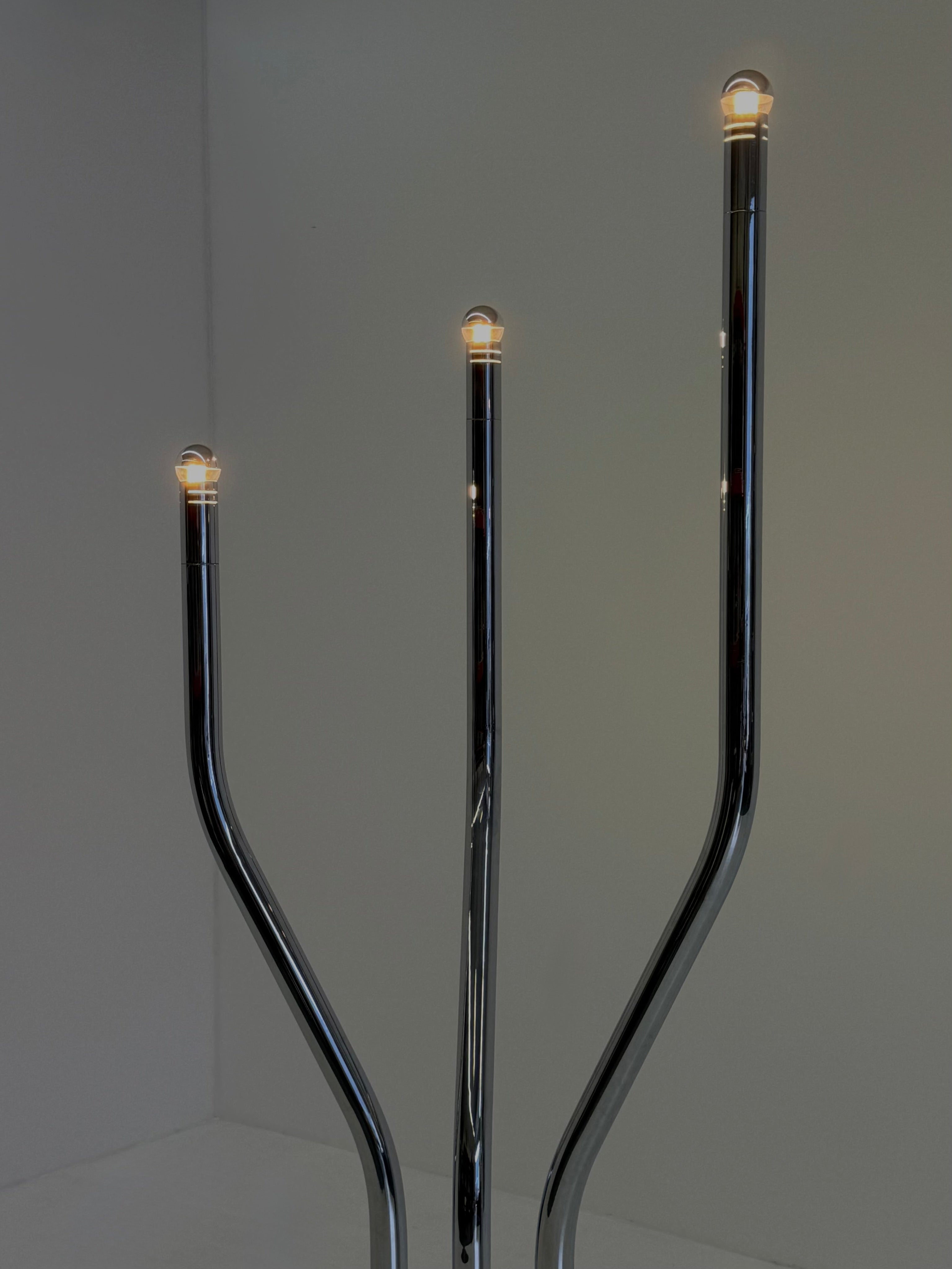Chrome tubular frame designer floor lamp by Goffredo Reggiani — lifestyle setting