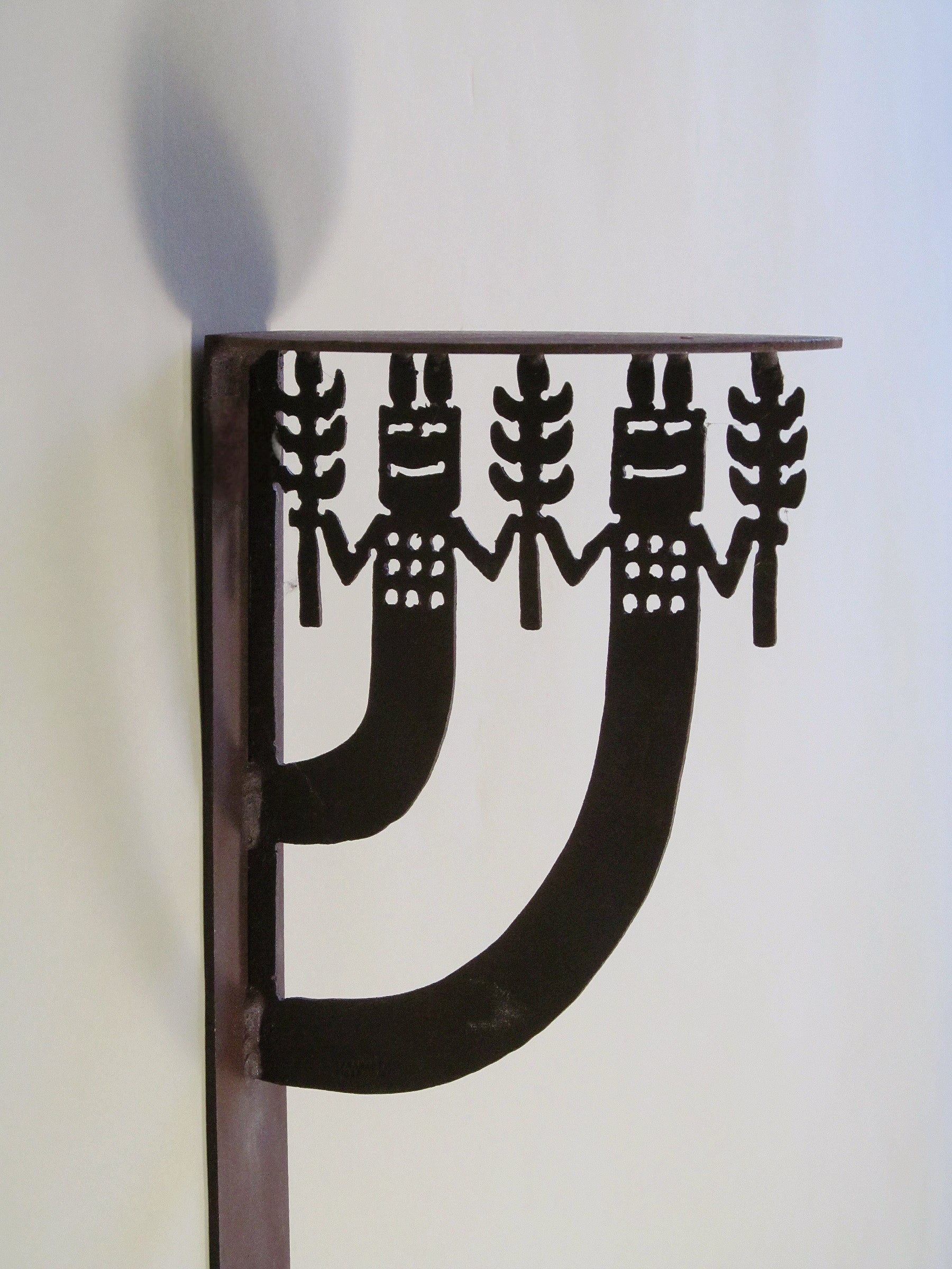 Rosemary Pozzi Franzetti Wall Mounted Shelves — close-up of black metal bracket design