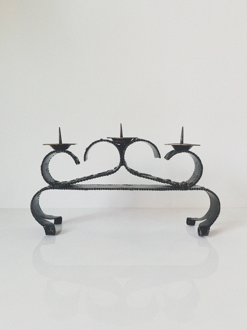 Black wrought iron candelabra with curved scrollwork from Poland