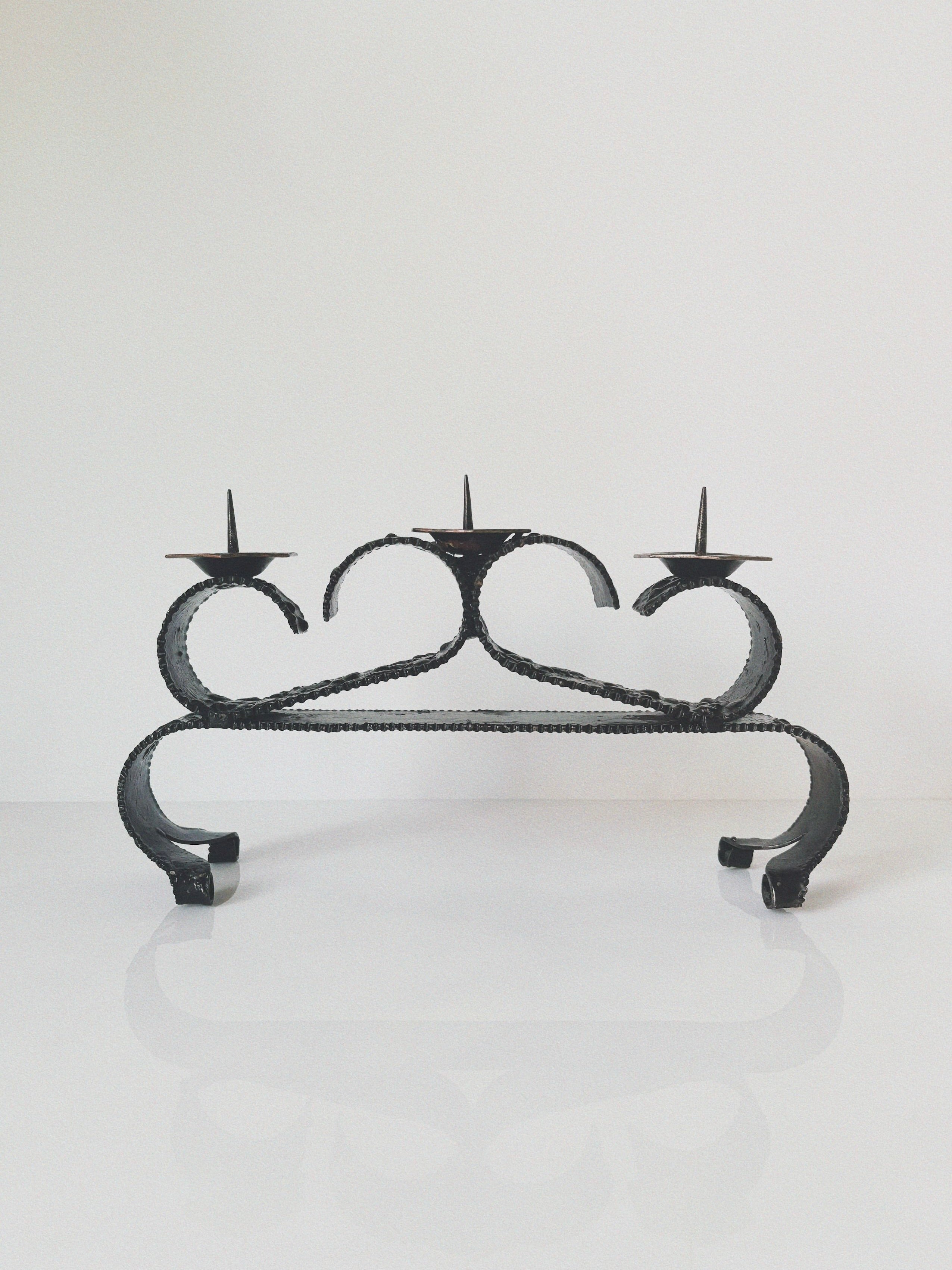 Black wrought iron candelabra with curved scrollwork from Poland