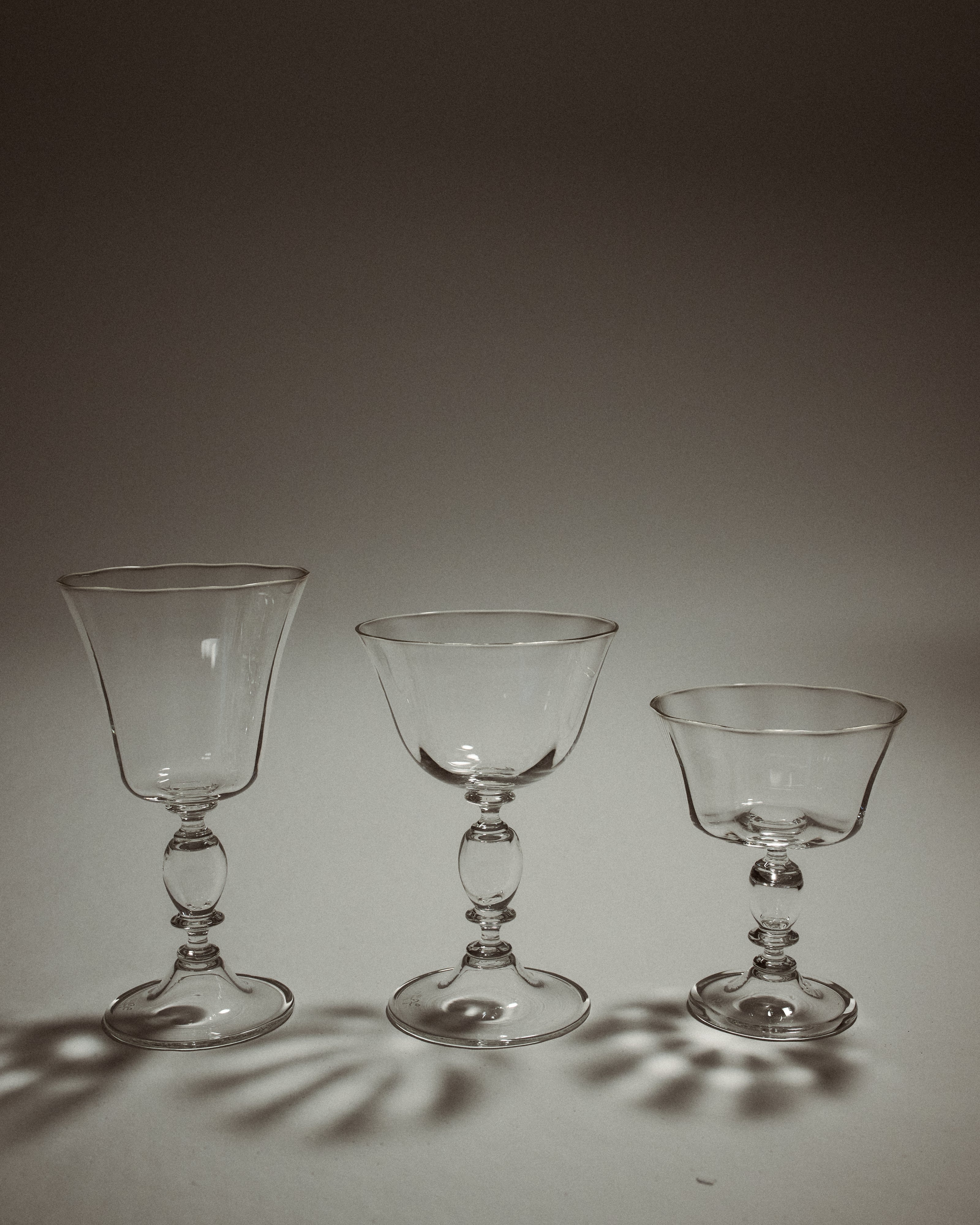 Alban Champagne Glass - Set of Four — three glass styles on neutral background