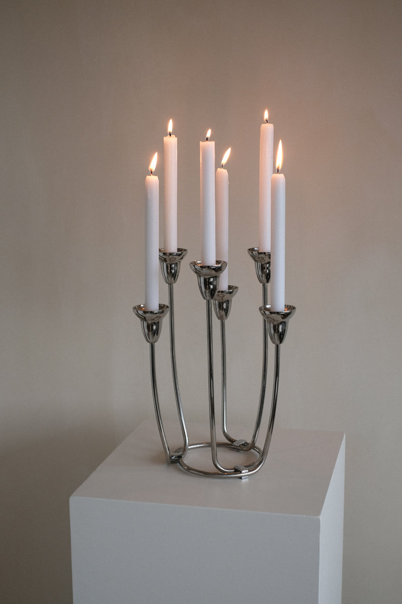 Large Candleholder — close-up of polished metal with lit candles