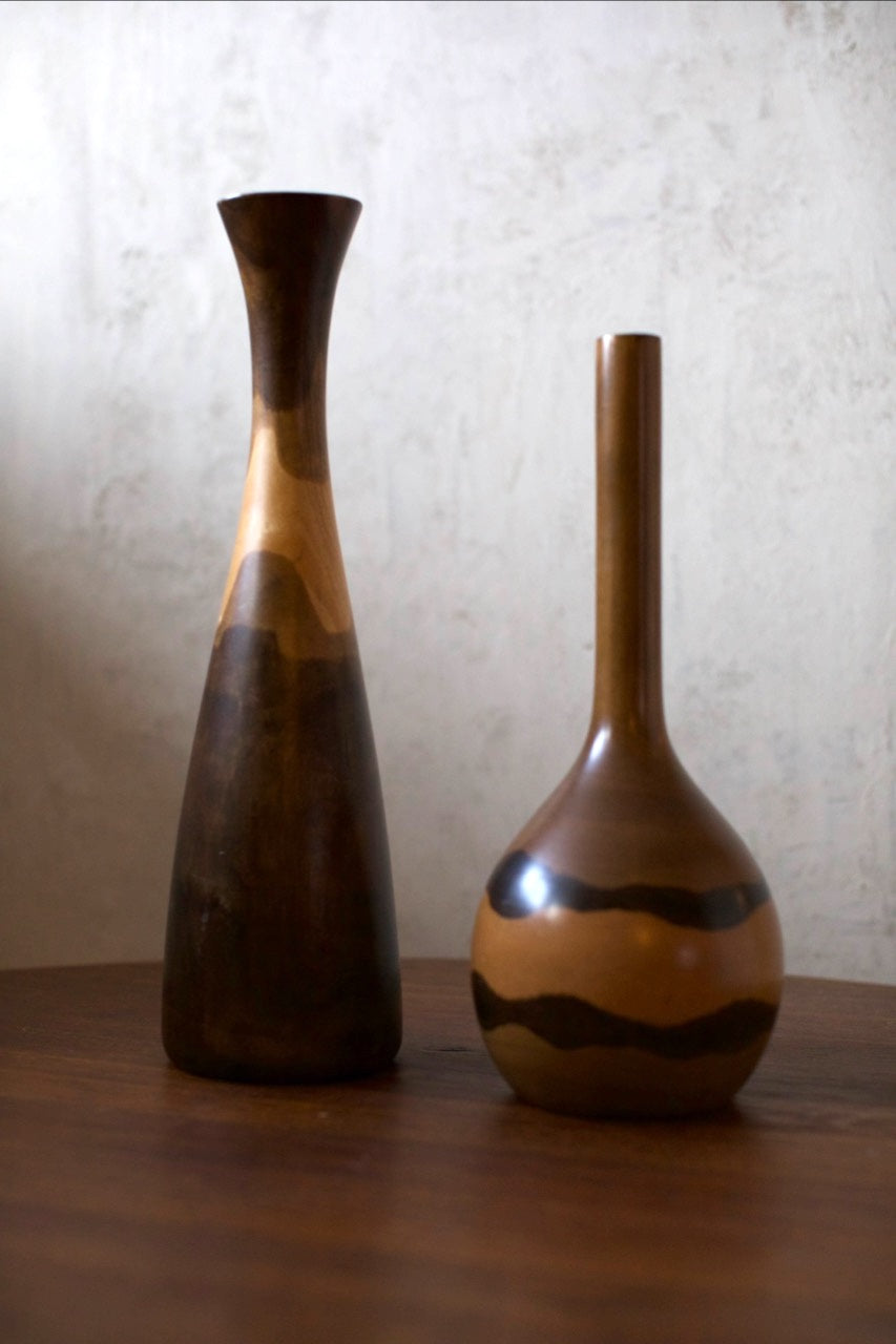 Wooden Vases — two handcrafted vases on wooden table