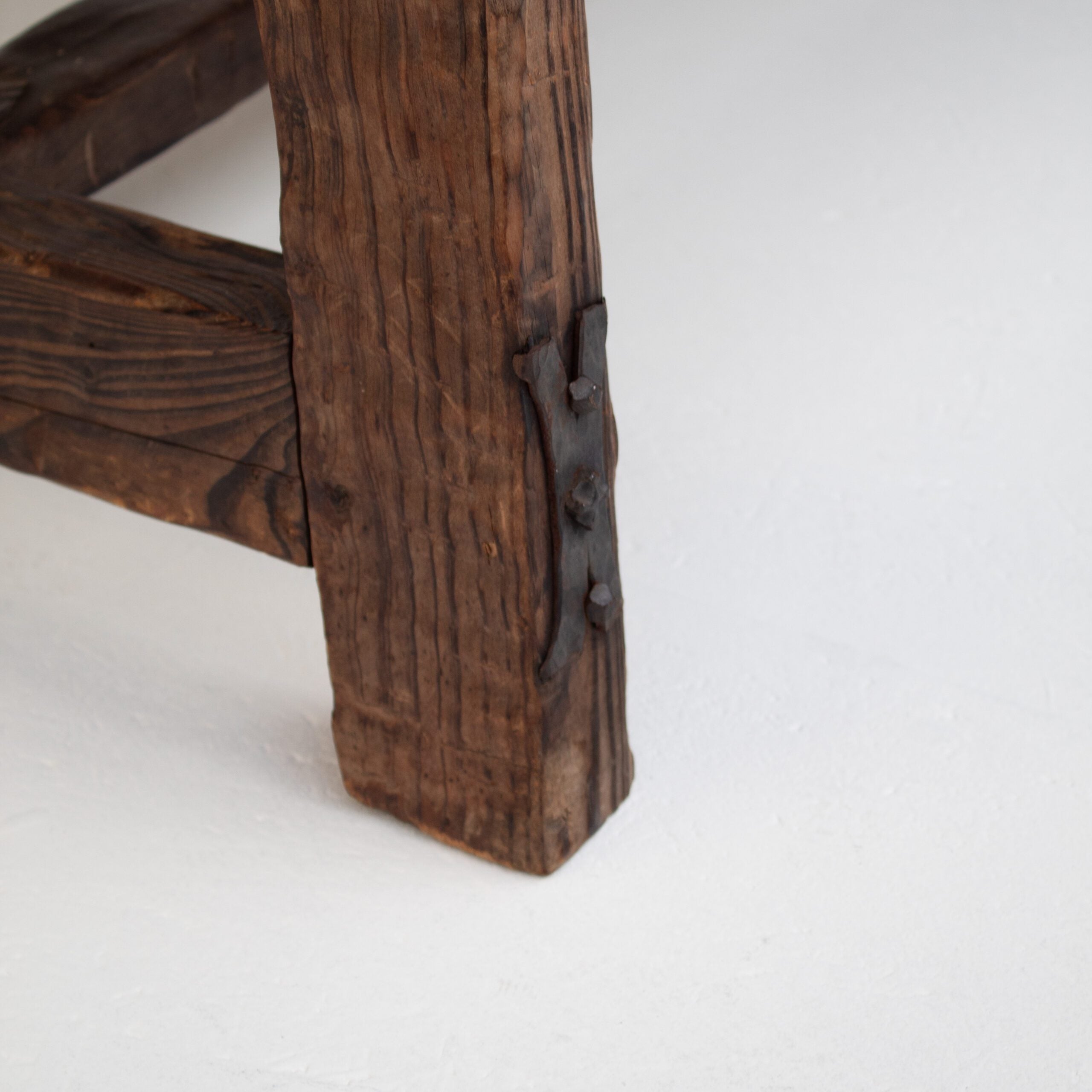 Brutalist Solid Wood Coffee Table — close-up of rustic wooden leg detail
