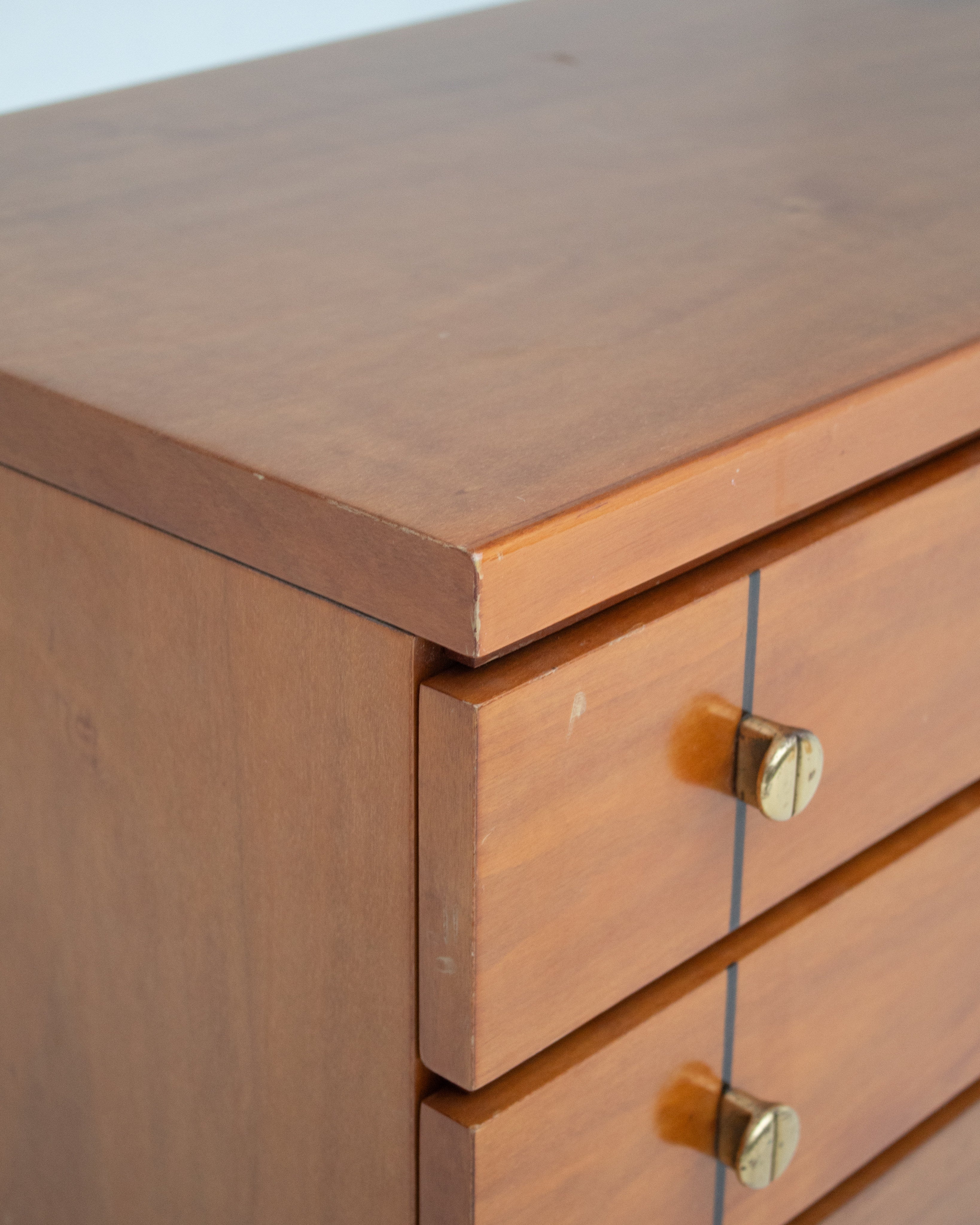 Set of Mid Century Nightstands in Wood — close-up of wooden surface with brass knob