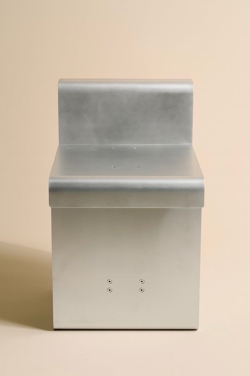 Aluminum chair backrest detail showing curved profile and mounting holes