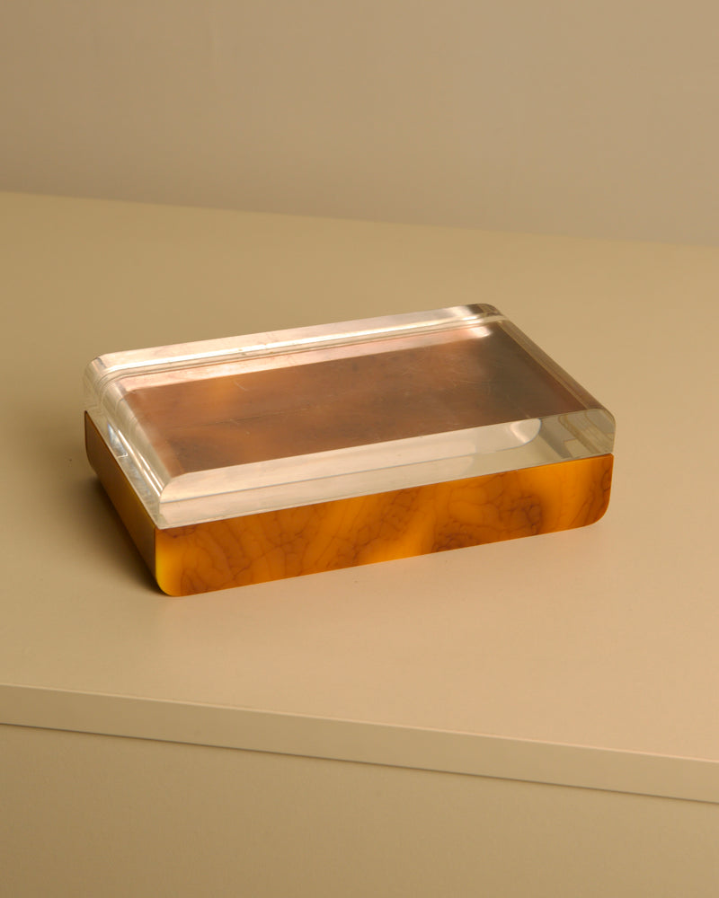 Italian 70s trinket box in plexiglass and brown bakelite — top view on neutral surface