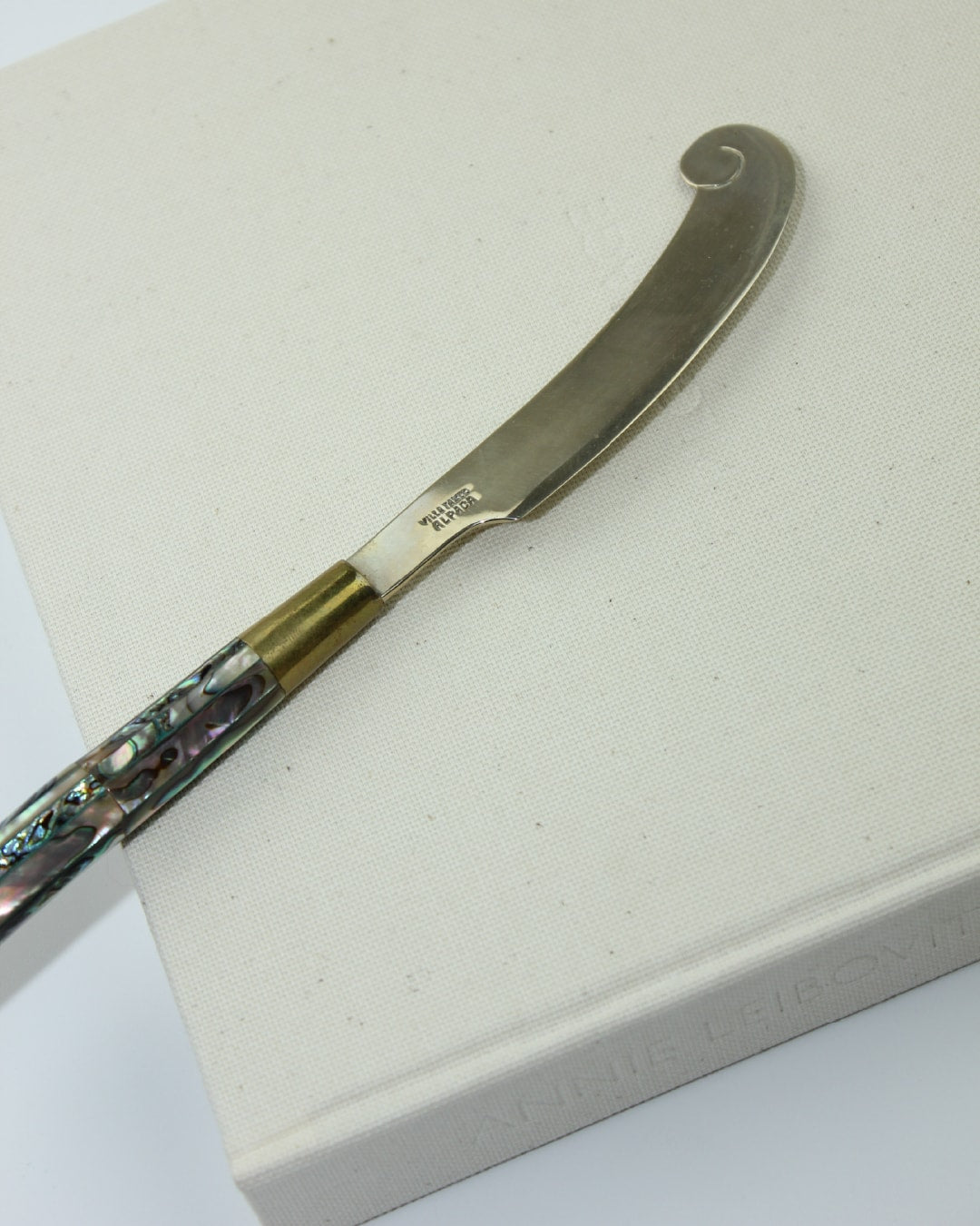 Vintage Abalone Knife — angled view on neutral fabric background