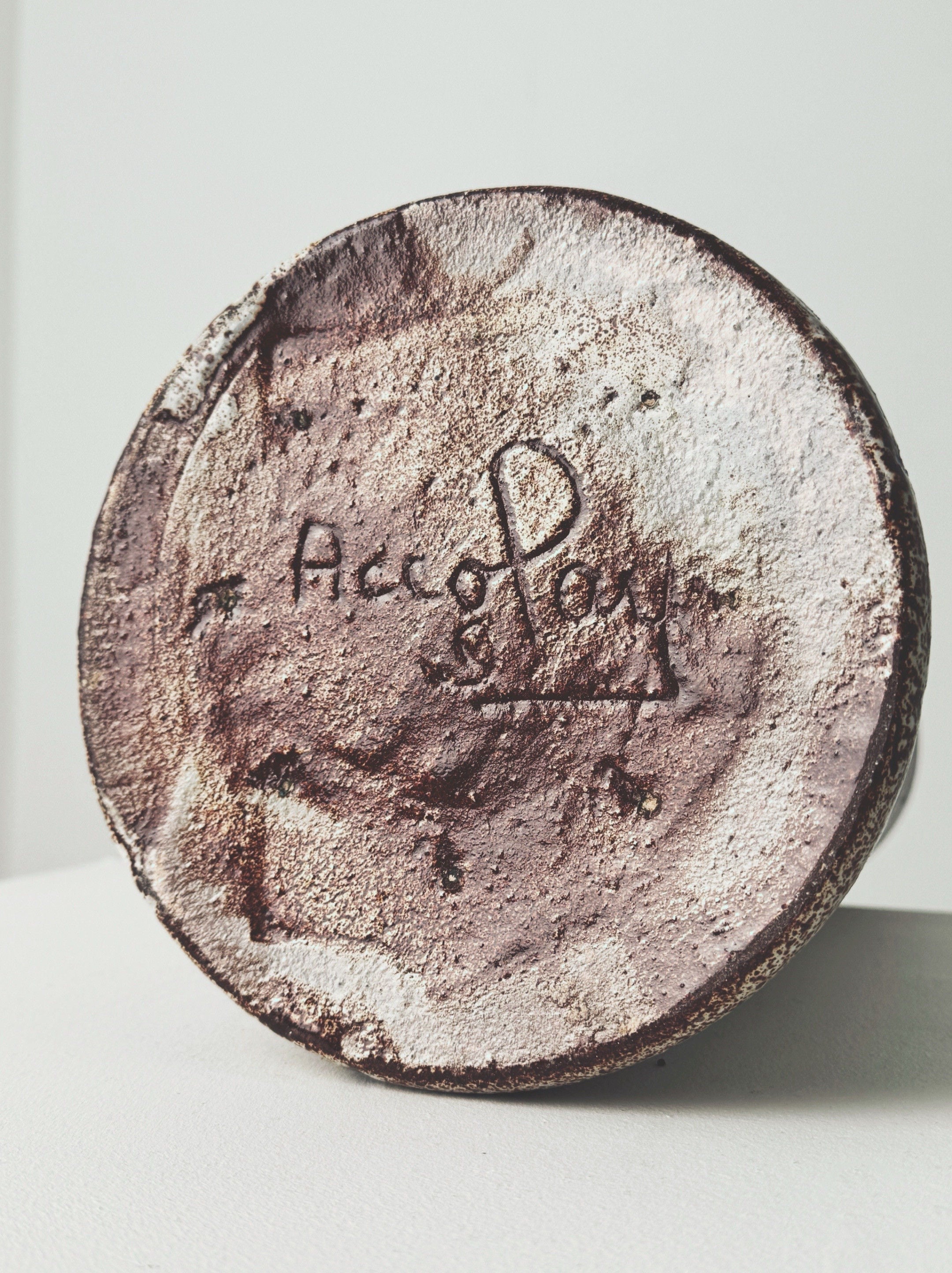 Bottom signature detail of Accolay pottery lamp base showing maker's mark